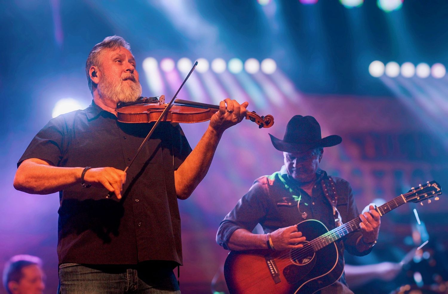 GG's Media Marketing
Tracy Byrd and His Fiddle Player Dale performing on stage under neon lights