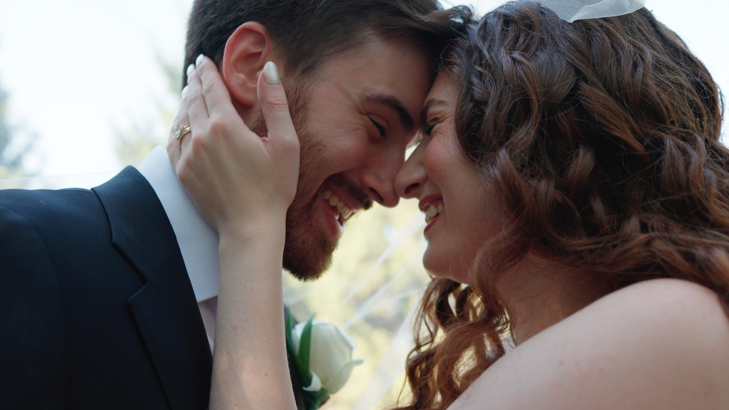 A romantic close-up of a couple sharing an intimate moment on their wedding day.