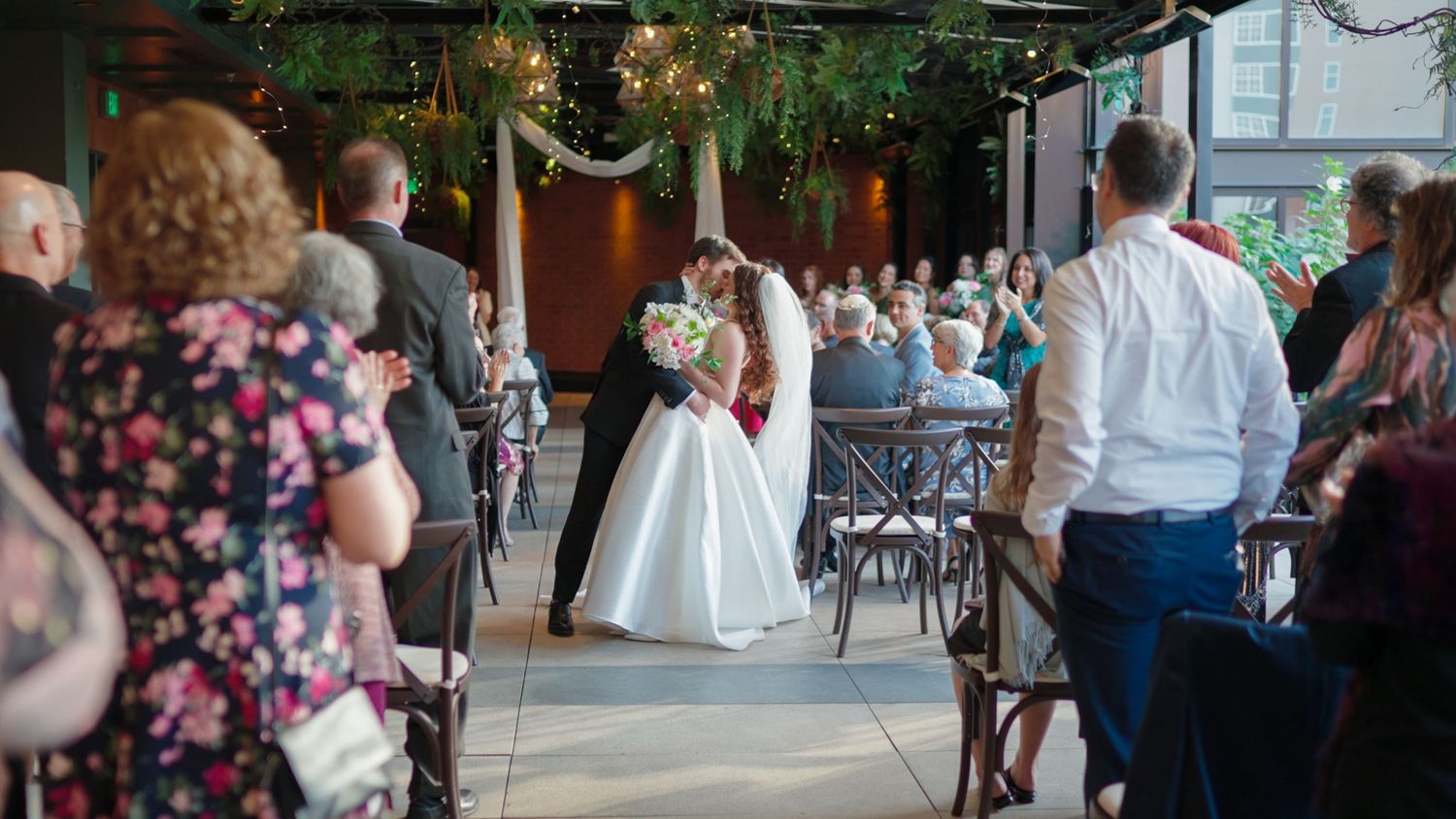 Indoor wedding reception space decorated with romantic lighting and rustic details.