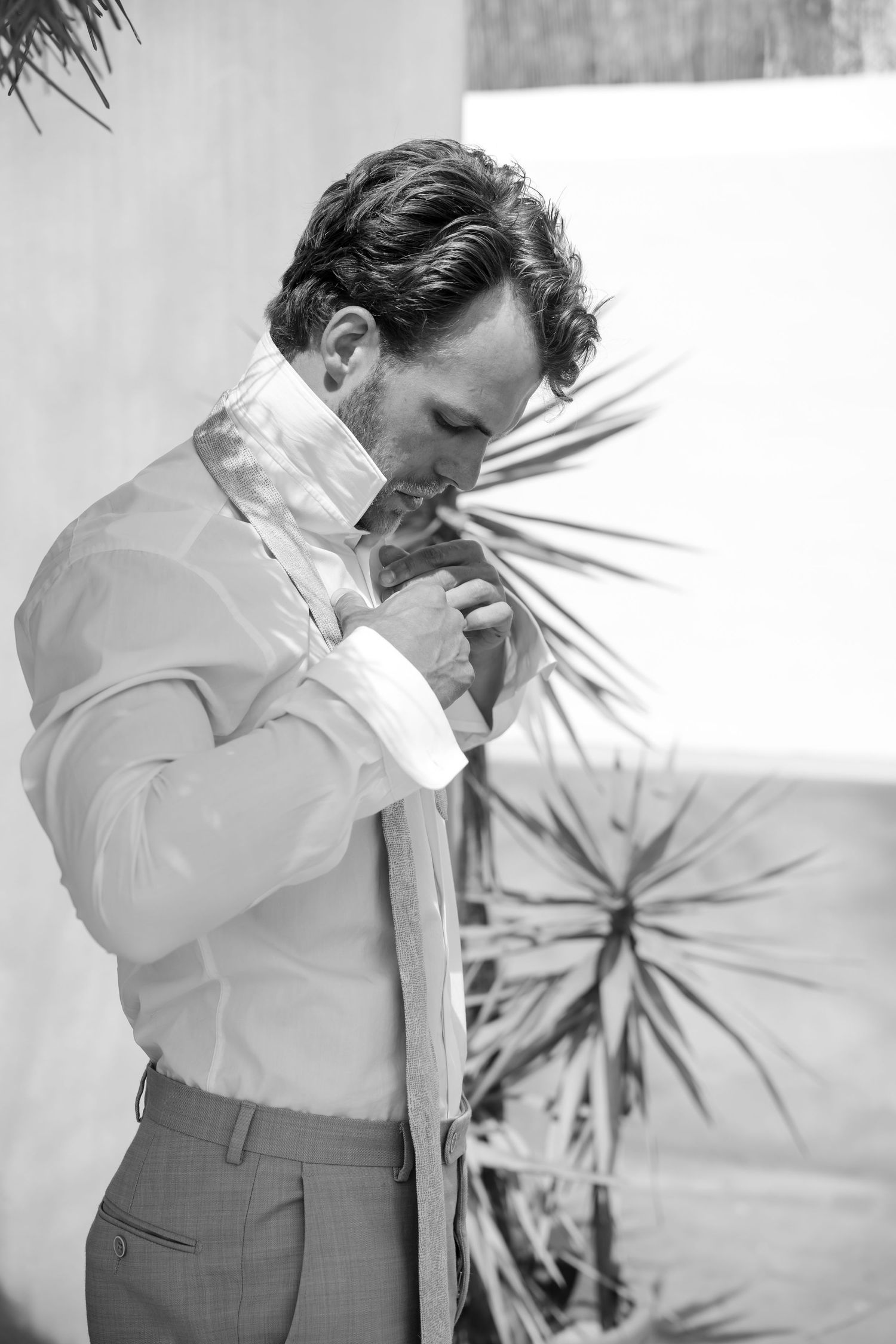 Black and white photo sequence showing emotional moments during wedding preparations.