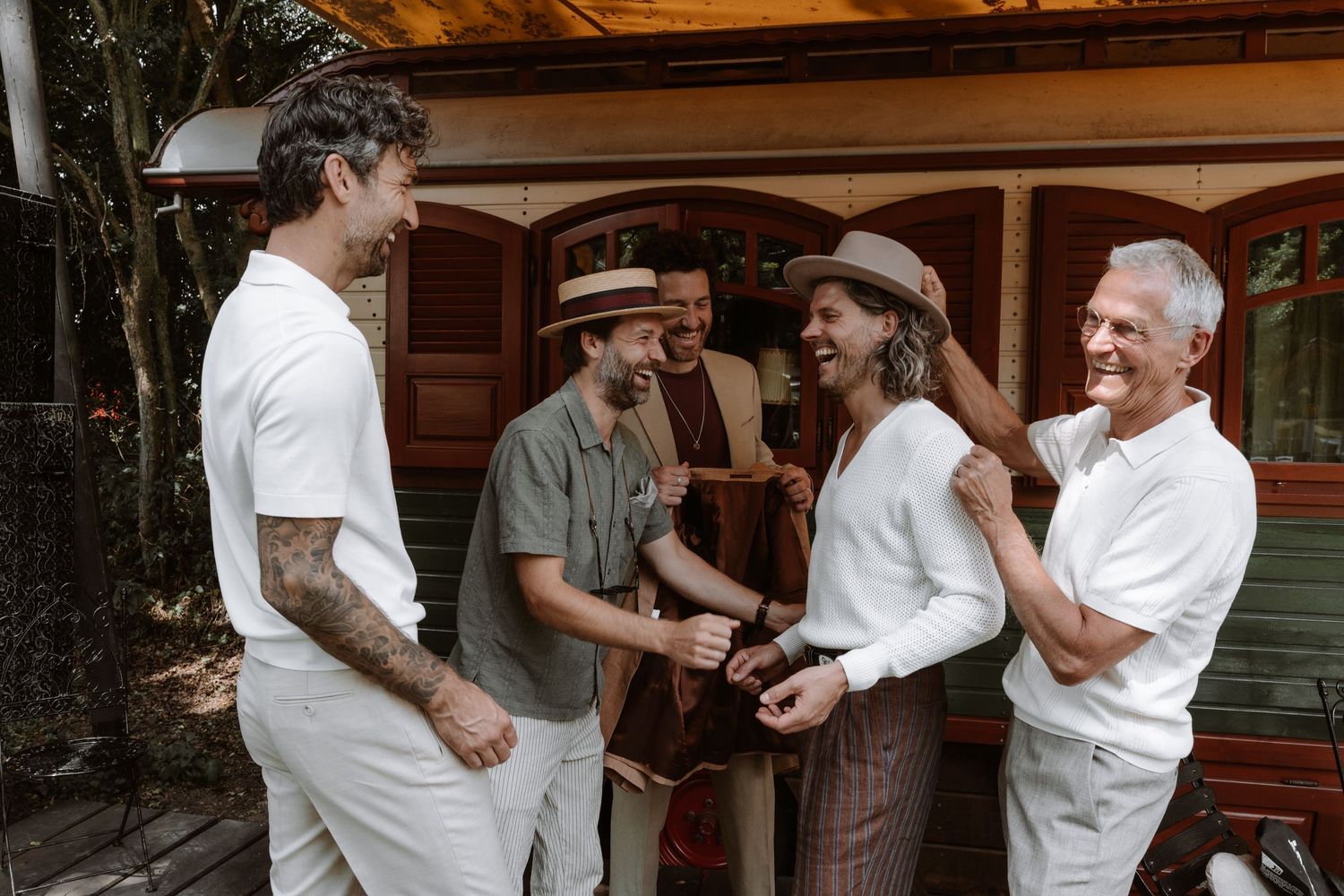 Candid moments of people hugging and celebrating in vintage-inspired outfits.