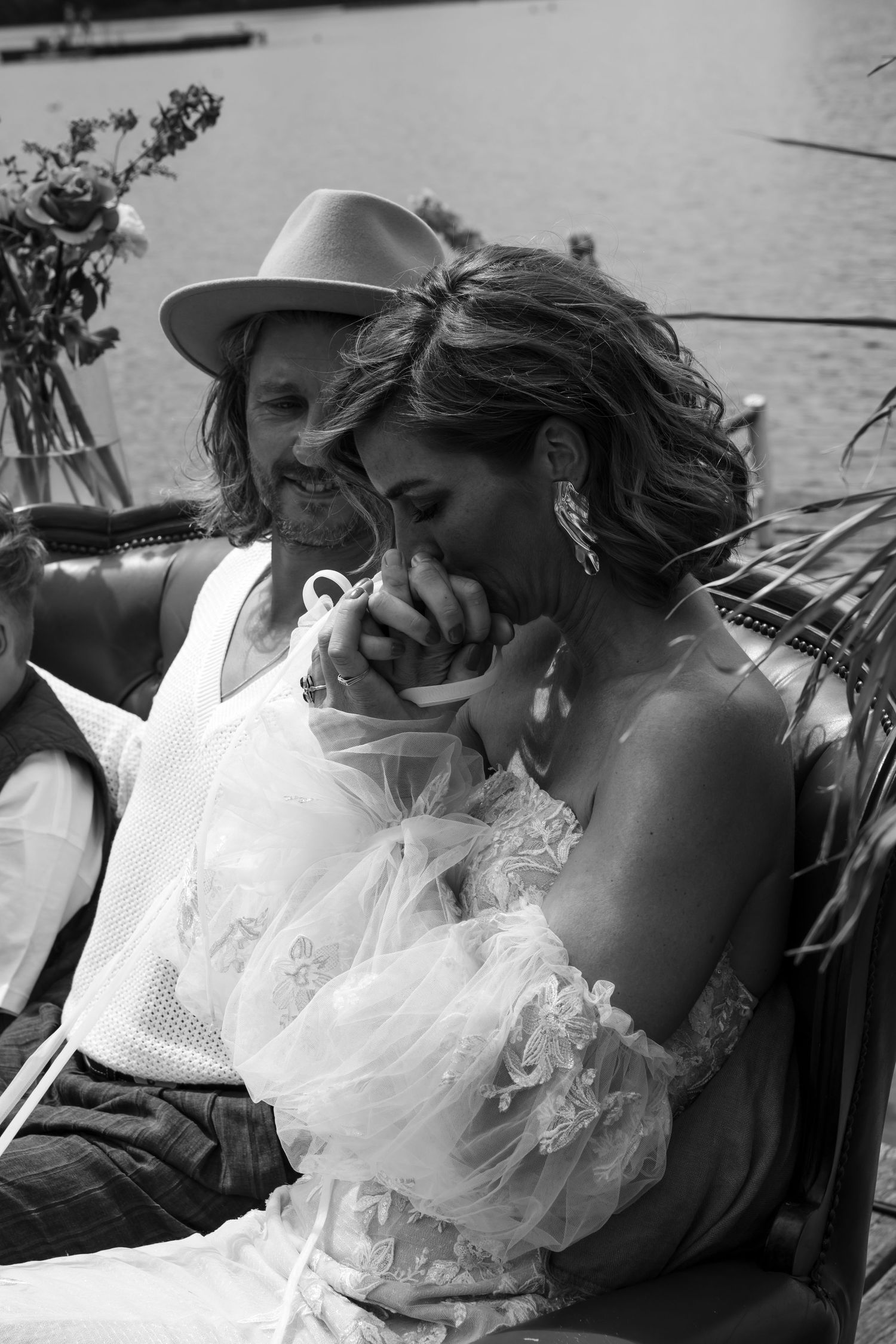 Black and white wedding photography capturing intimate moments by the water.