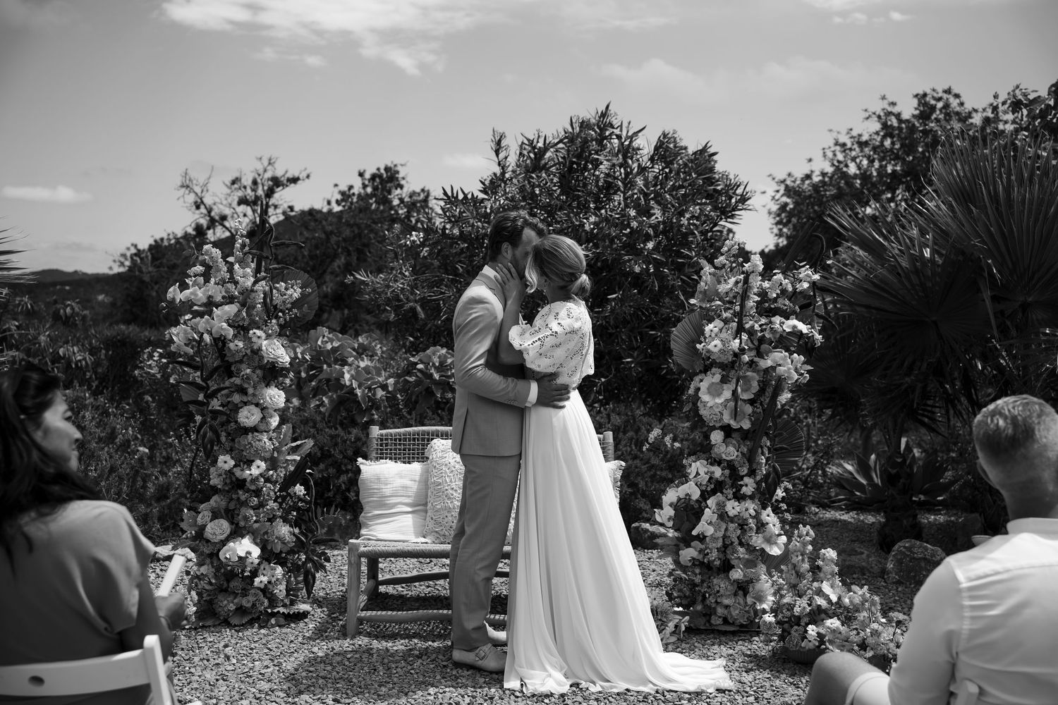 Wedding ceremony moments captured in black and white at an outdoor garden venue.