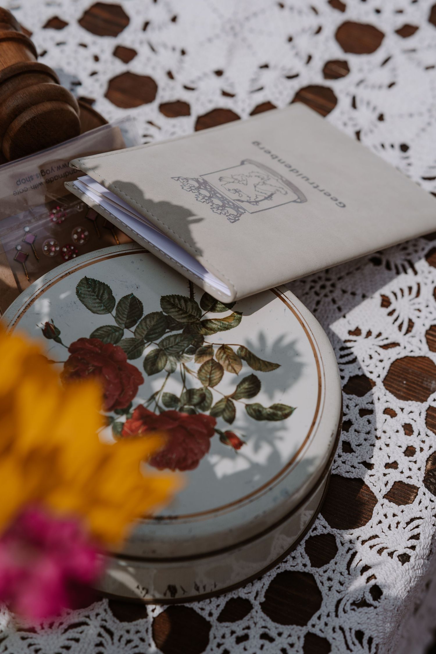 Vintage lace doily with floral embroidery and delicate paper details in a romantic setting.