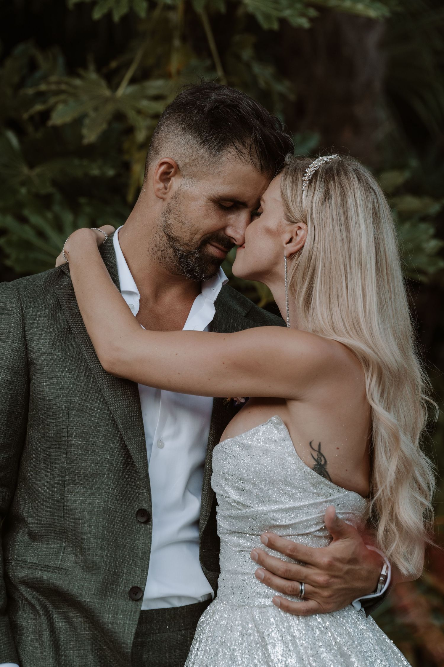A romantic couple shares intimate moments in a series of wedding photos against a natural outdoor backdrop.