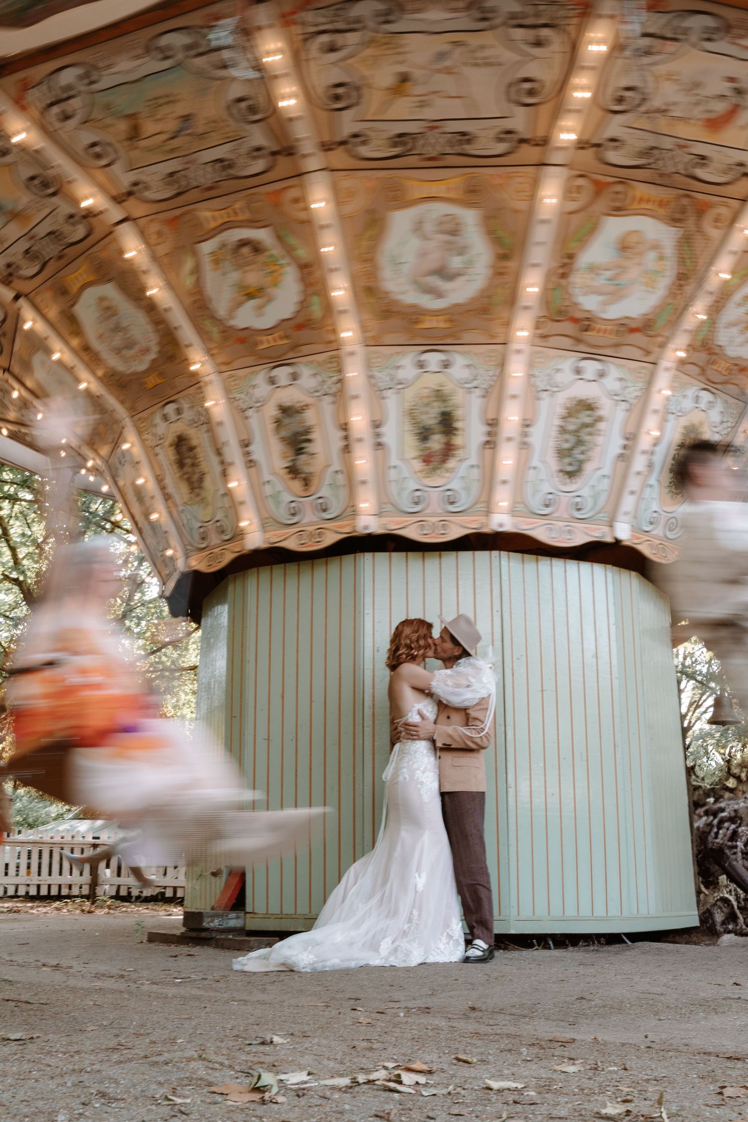 A wedding dress spins beneath an ornate carousel ceiling creating a dreamy motion blur effect.