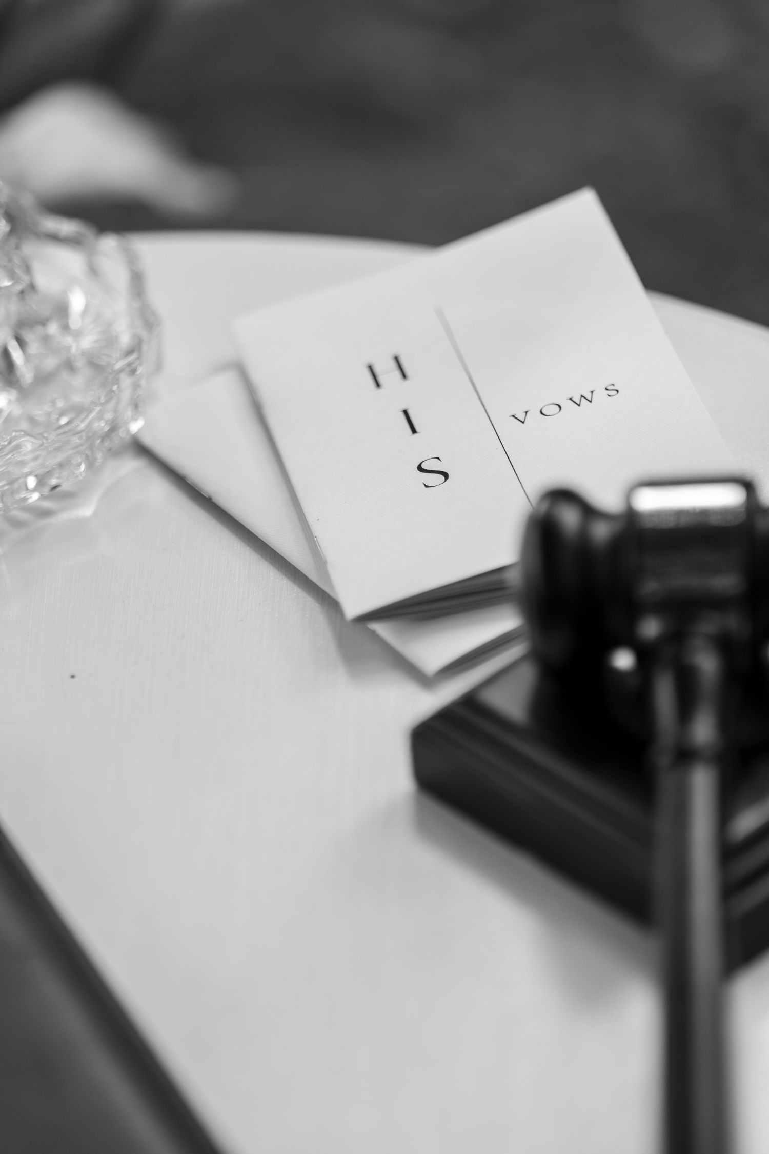 Black and white detail shot of wedding vows and ceremony papers.