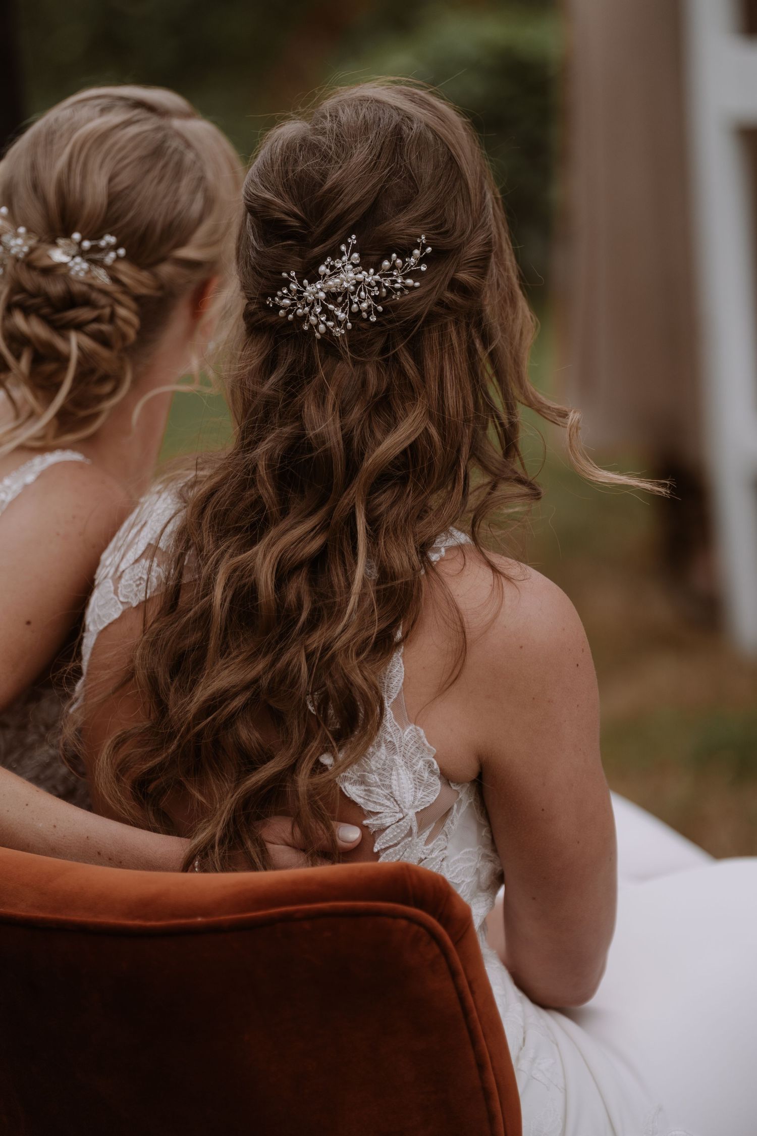 Close-up of elegant bridal hairstyles adorned with crystal hair accessories.