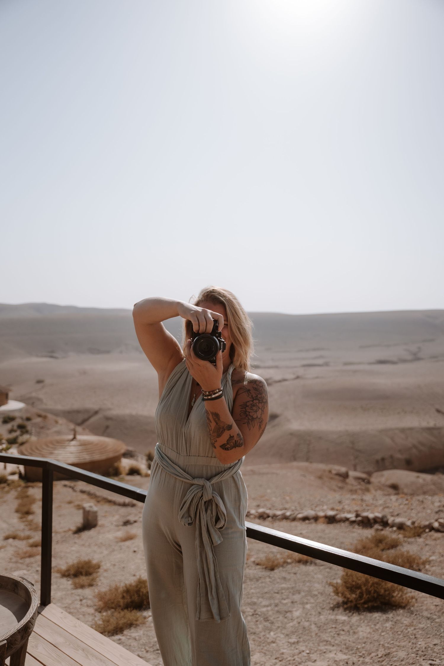 Desert landscape photography session with photographer taking pictures from viewing platform.