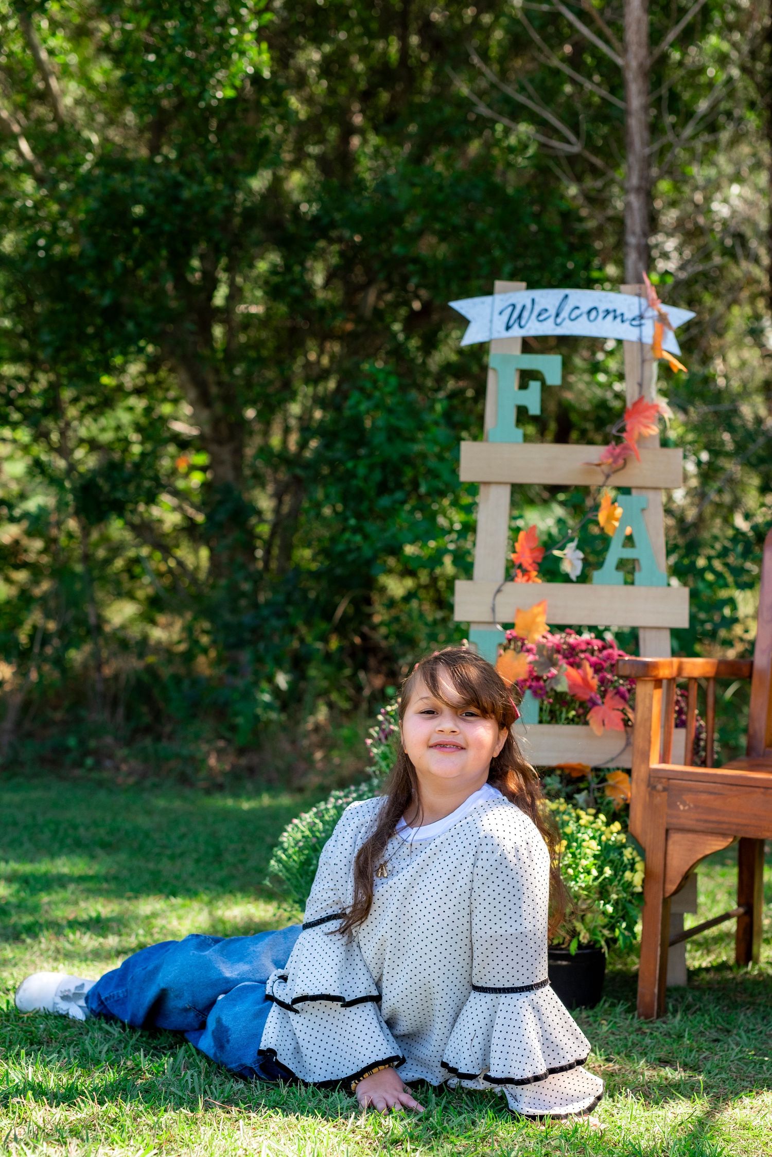 Young girl posing in a natural outdoor setting during a children’s portrait photography session.