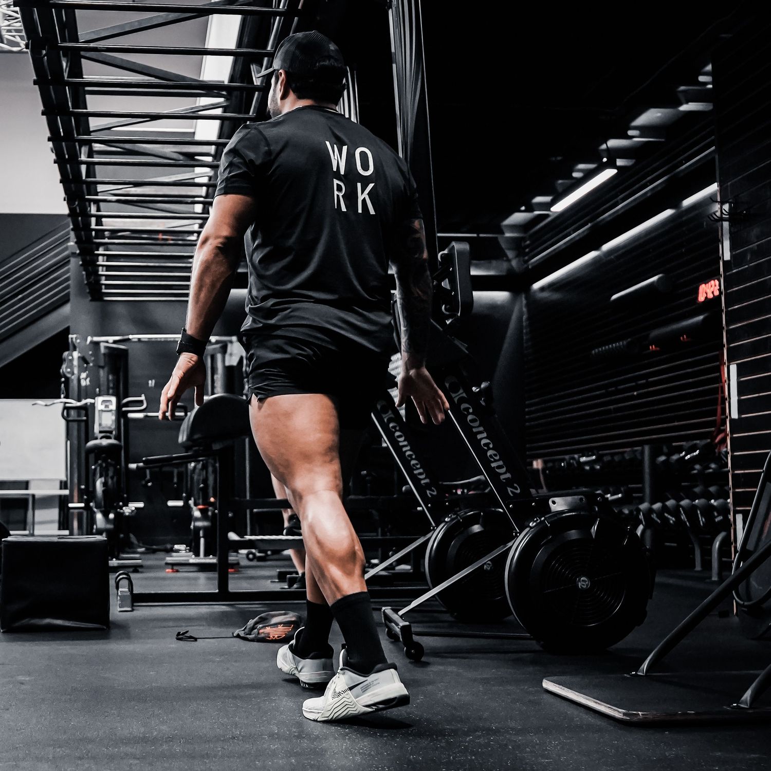 Fitness influencer photoshoot by TenX Captures walking away while coaching at Austin gym for social media content.