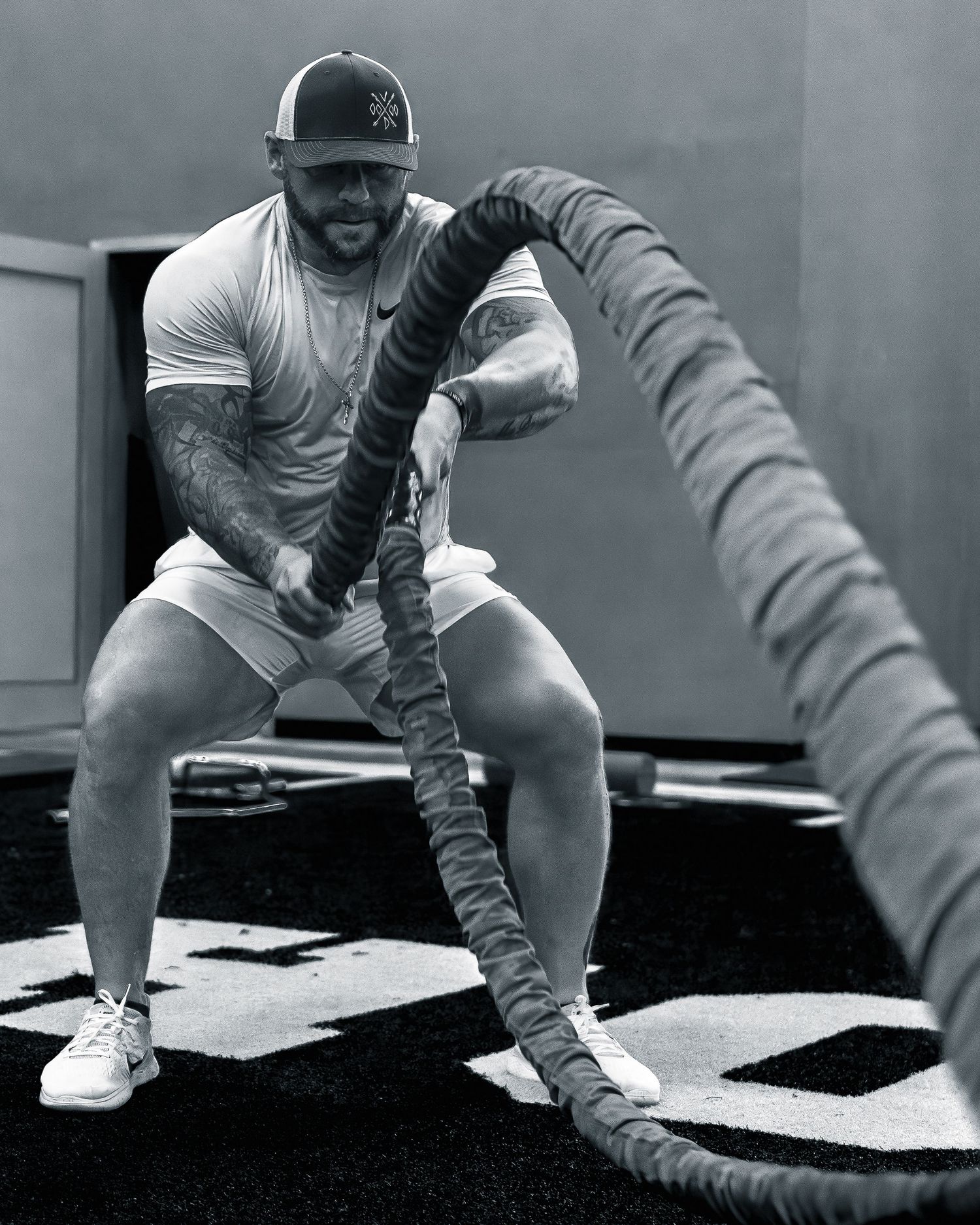 Fitness influencer photoshoot by TenX Captures doing battle ropes at gym in Austin for social media content.