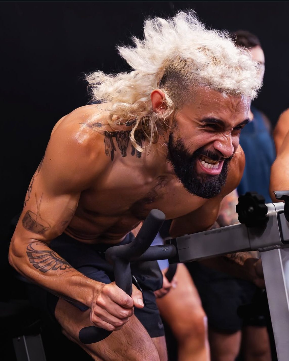 Fitness influencer photoshoot by TenX Captures of influencer working out on stationary bike in Austin gym for social media content.