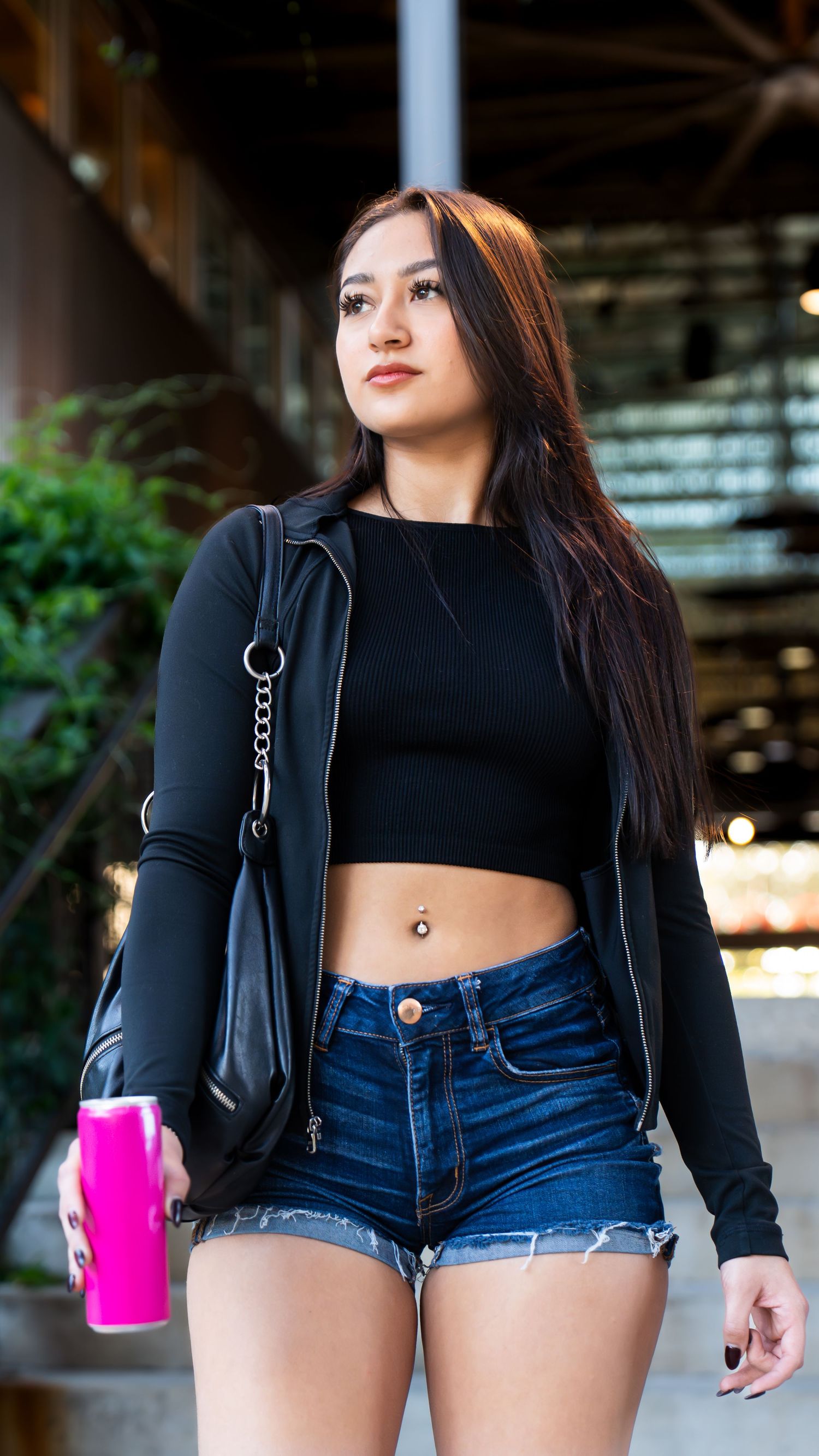 Personal portfolio photoshoot by Ten X Captures featuring female model walking down stairs holding a can looking away in San Antonio.