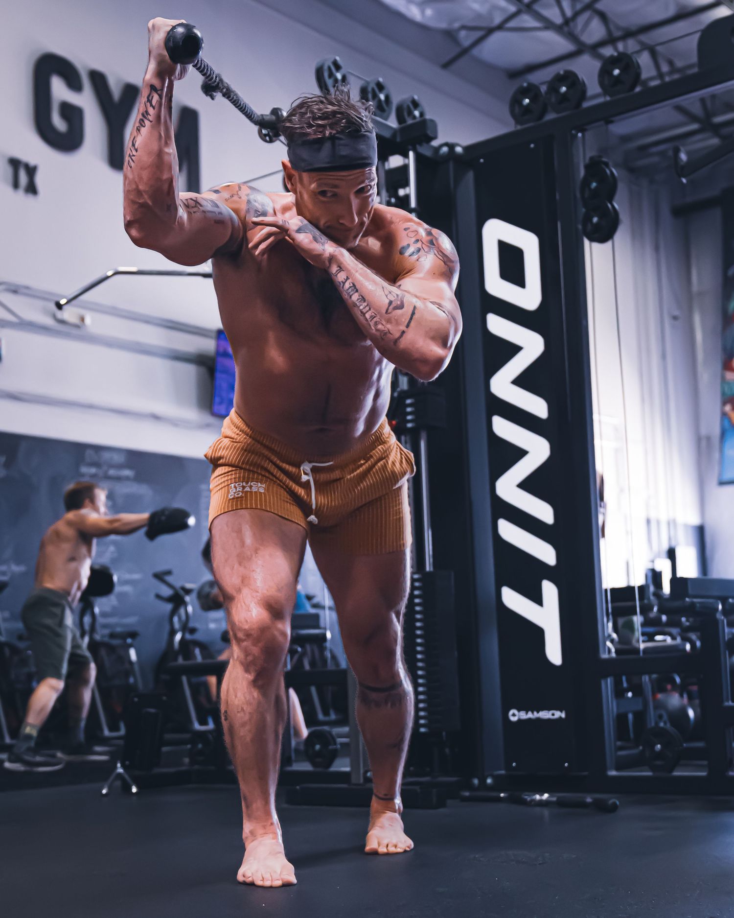 Fitness influencer photoshoot by TenX Captures doing triceps extensions at Austin gym for social media content.