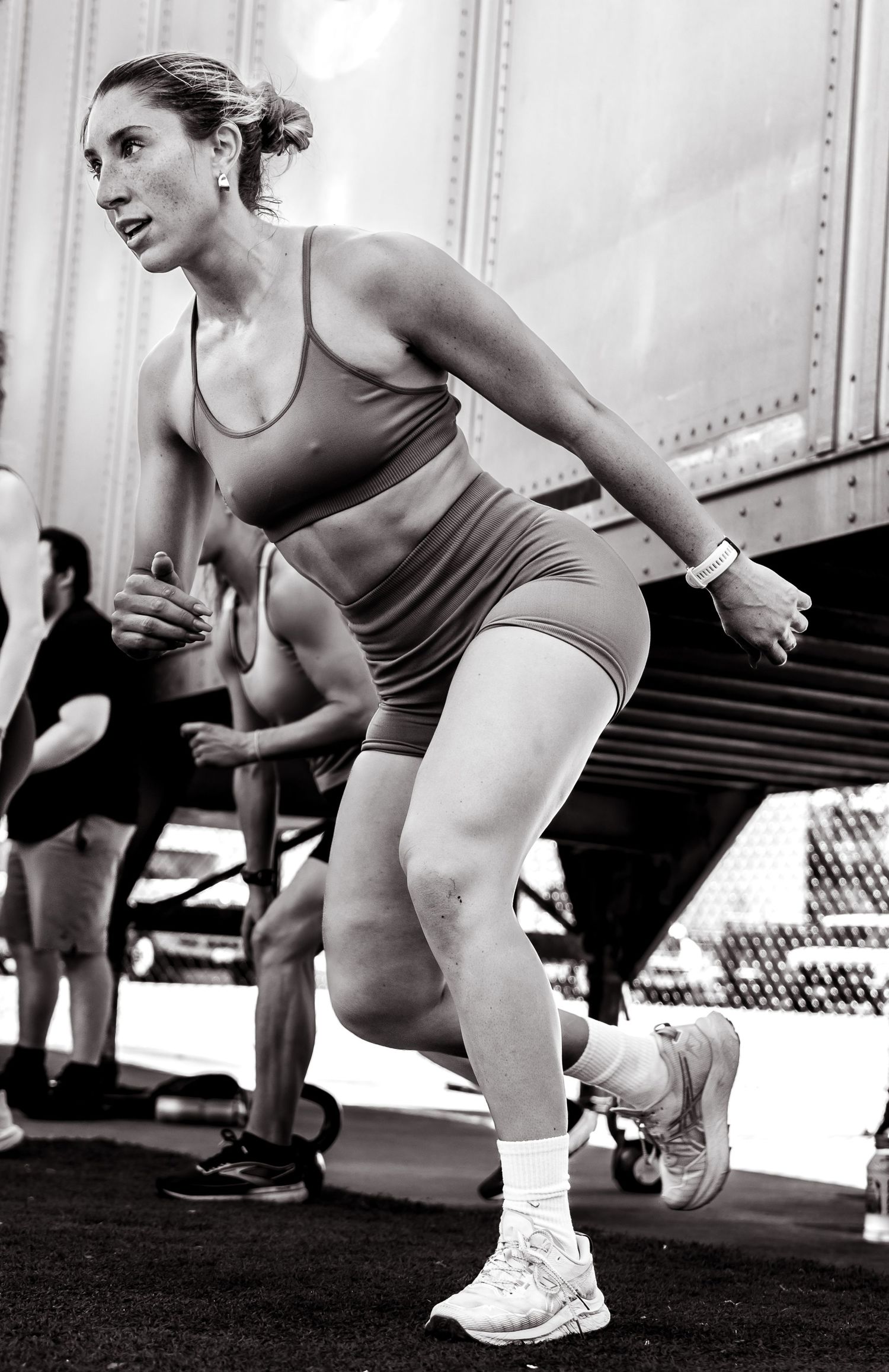 Female fitness influencer photoshoot by TenX Captures going squats outdoors in Austin for social media content.