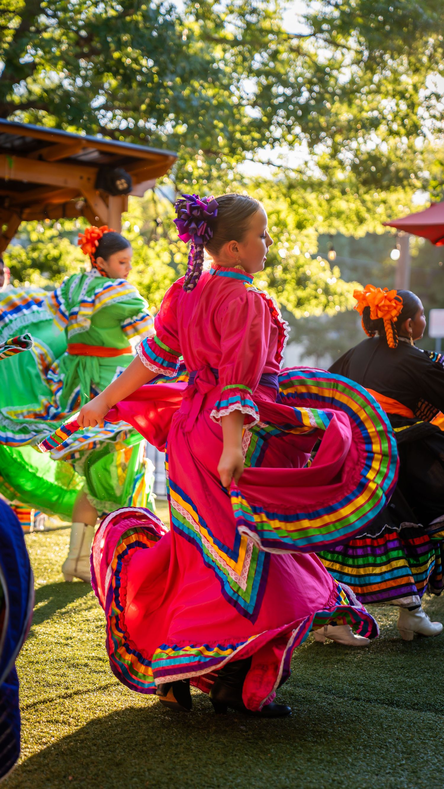 Dancing in colorful Folklorico dress at San Antonio event, captured by Ten X Captures for event photography and video.