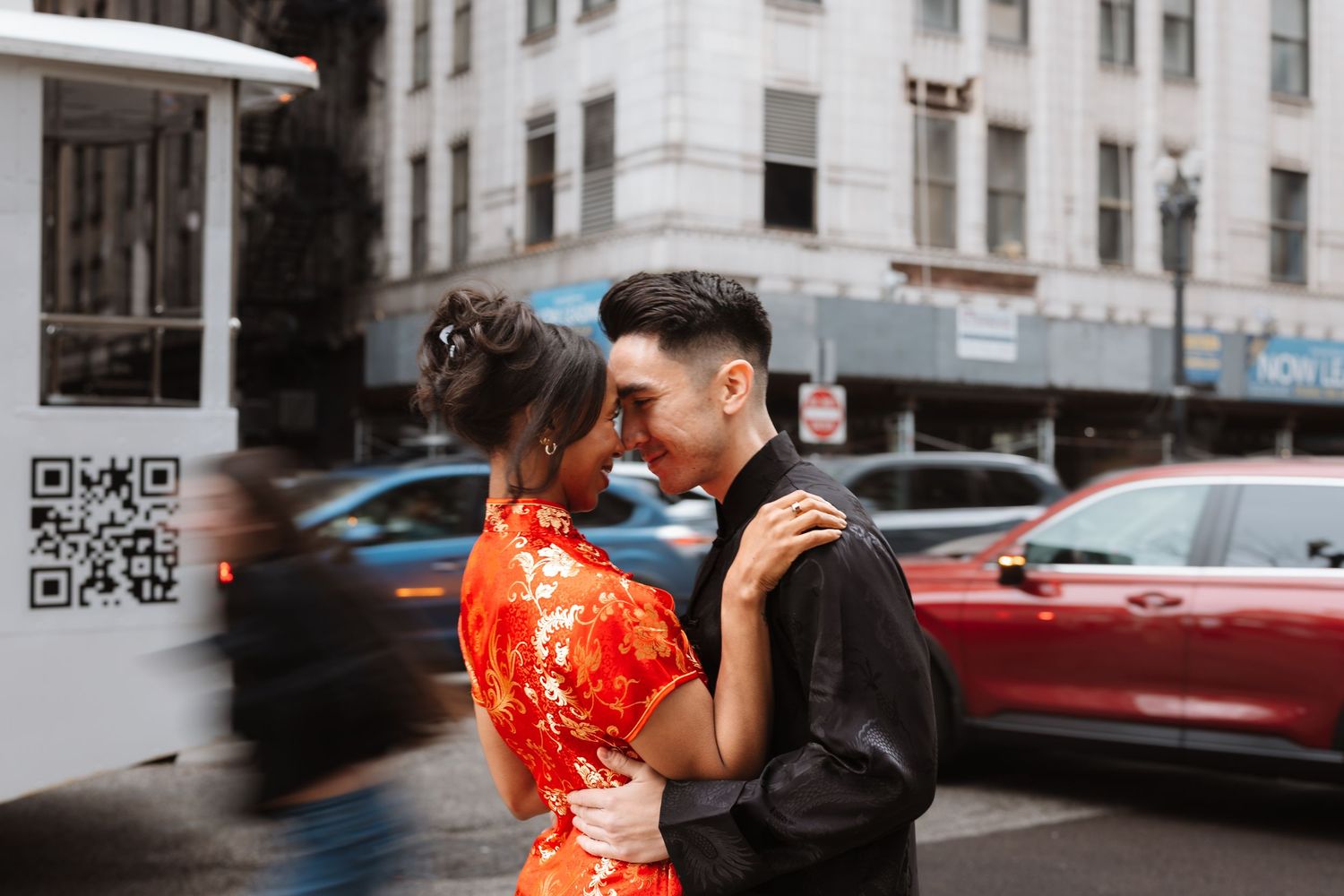 Interracial couple in traditional Chinese outfits sharing a tender moment on a busy city street.

Chicago Wedding Photographer