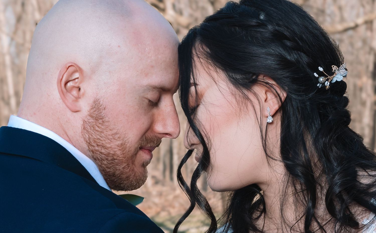 Close-up of bride and groom sharing an intimate forehead-to-forehead moment.