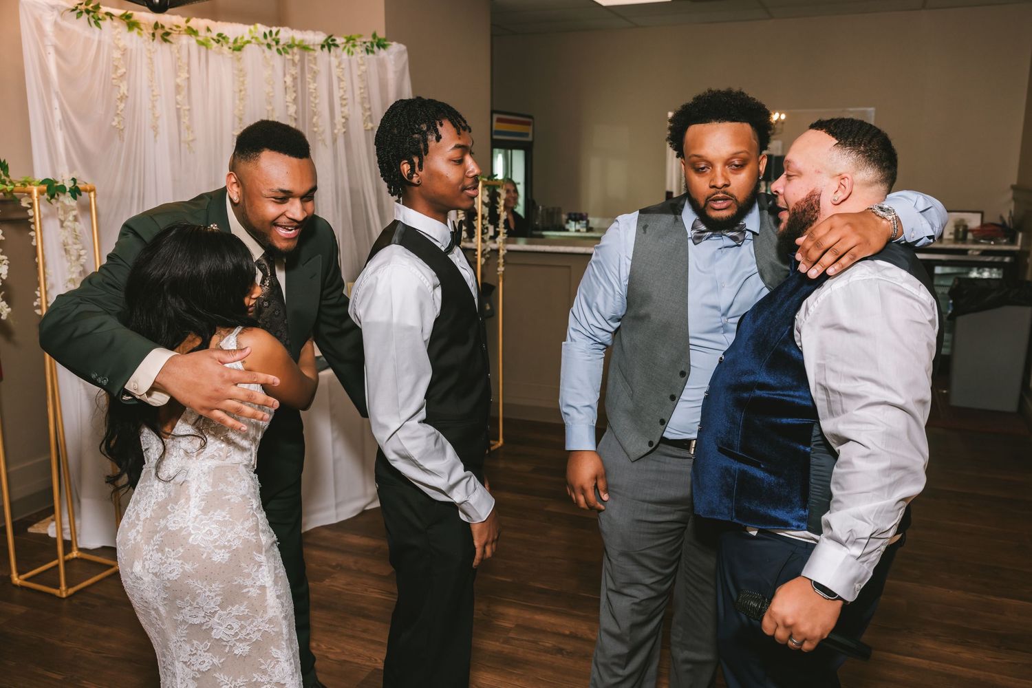 Joyful wedding guests embracing and celebrating on the dance floor.