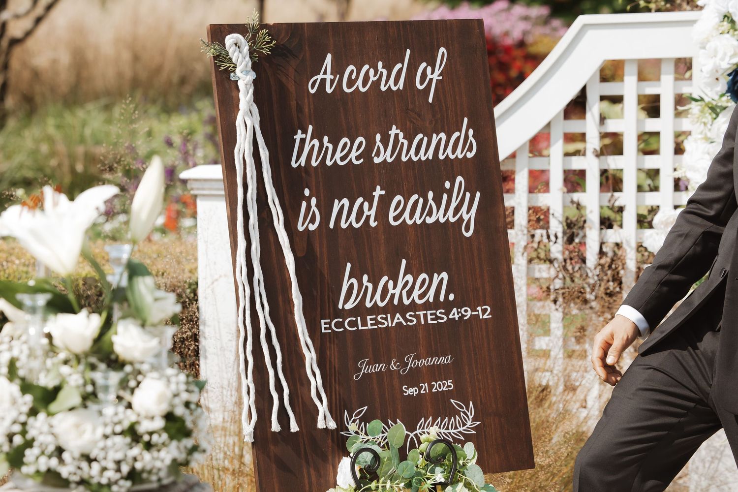 Wooden wedding sign reading A cord of three strands is not easily broken Ecclesiastes 4:9-12.