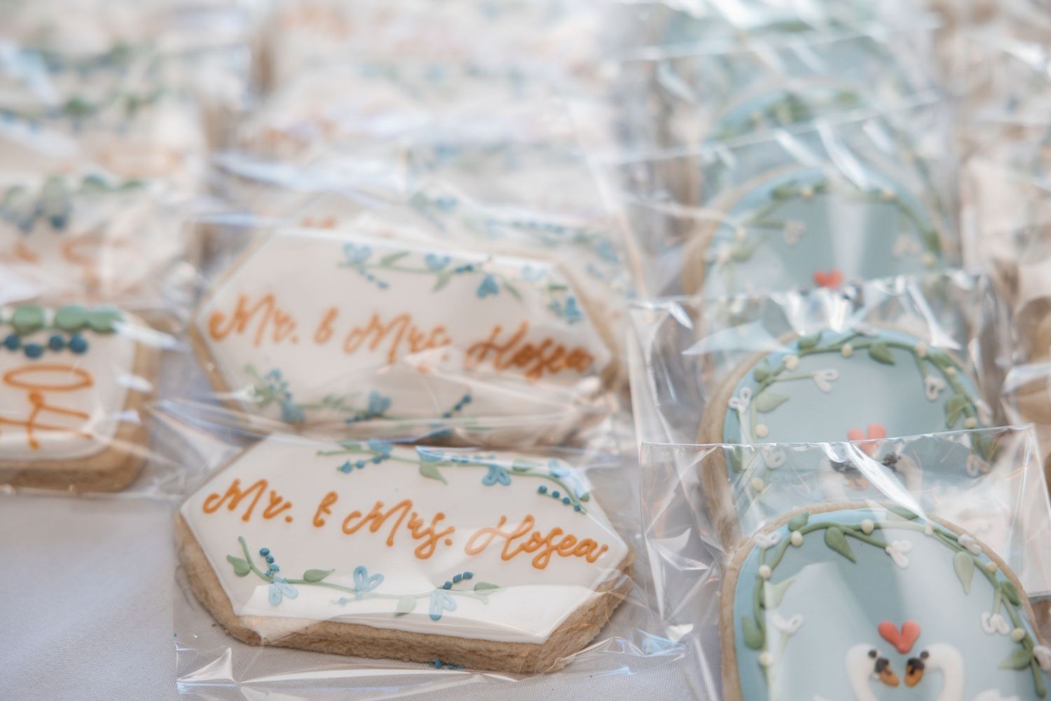 Custom wedding sugar cookies reading Mr. and Mrs. wrapped in clear bags as wedding favors.