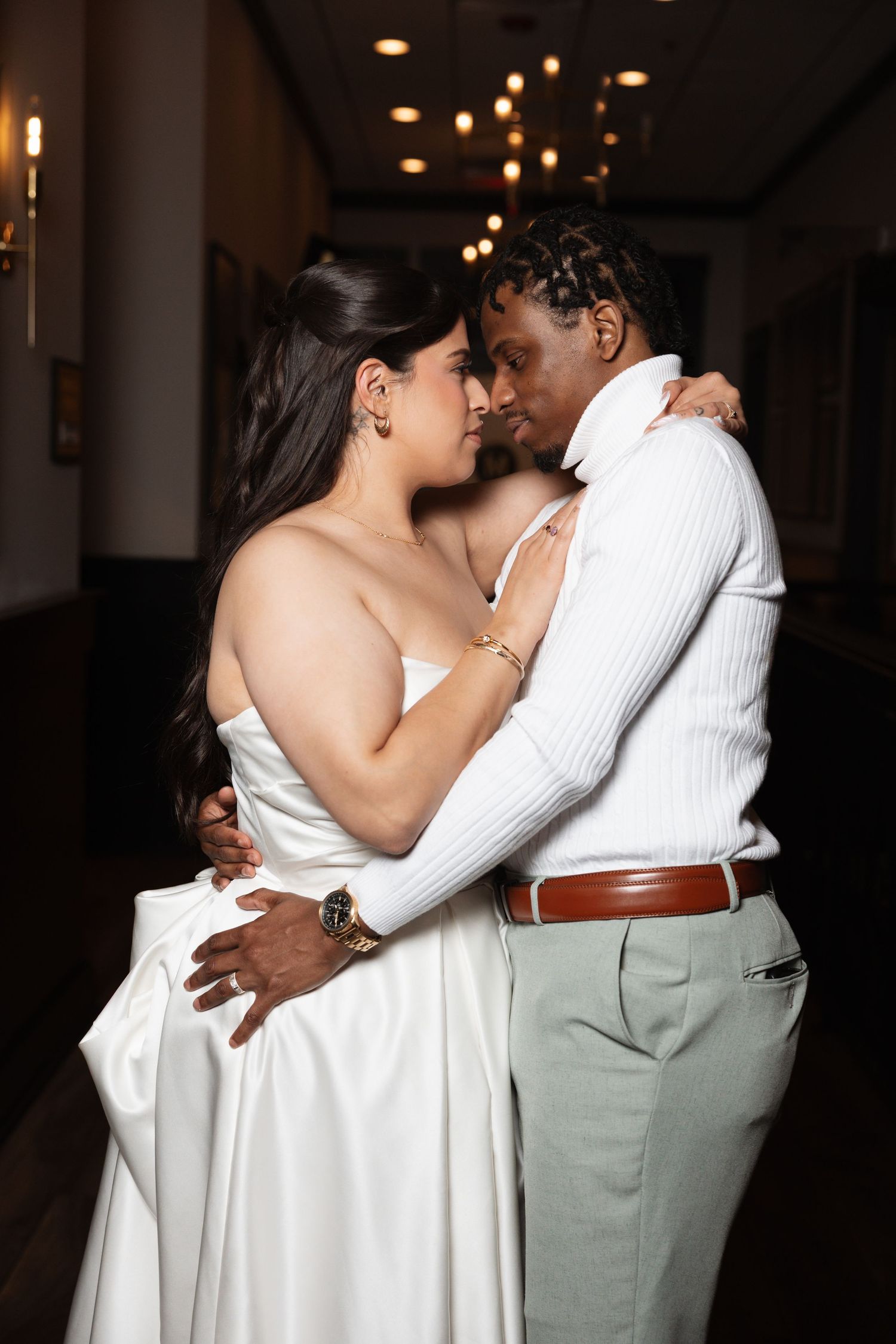 Bride and groom sharing an intimate embrace during their first dance at wedding reception.