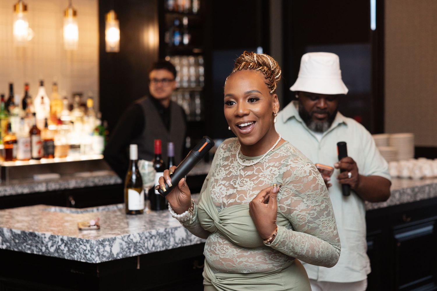 Woman smiling at a bar holding wine accessories with friends in a stylish venue.