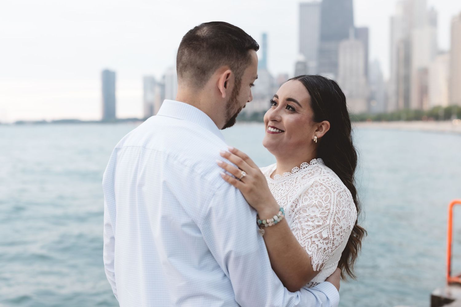 Couple sharing a romantic dance by Lake Michigan with Chicago skyline in the background.
