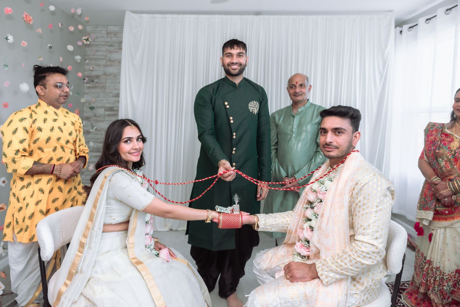 Indian bride and groom exchanging garlands at traditional Hindu wedding ceremony.