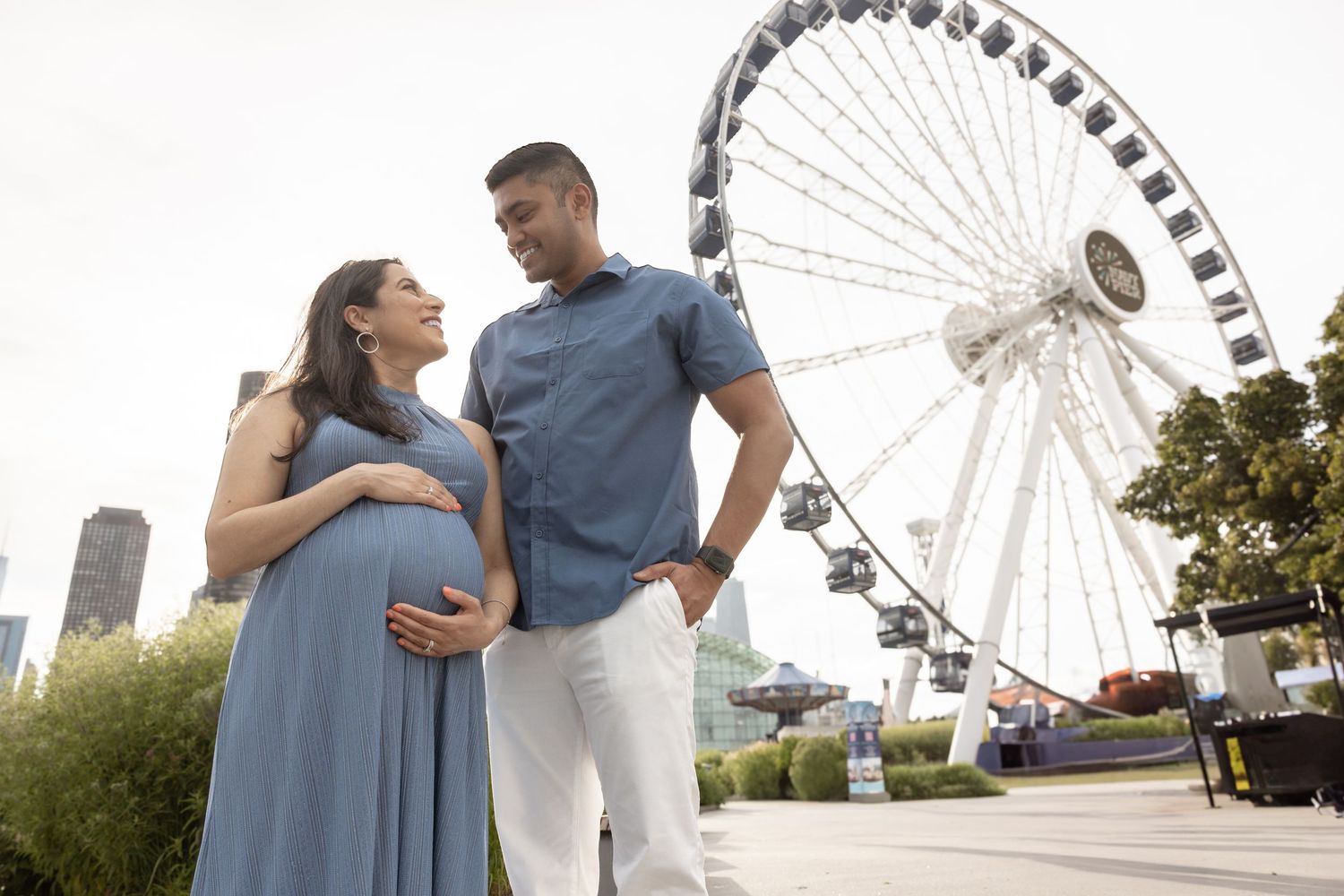 Happy couple sharing a smile during outdoor maternity photo session.