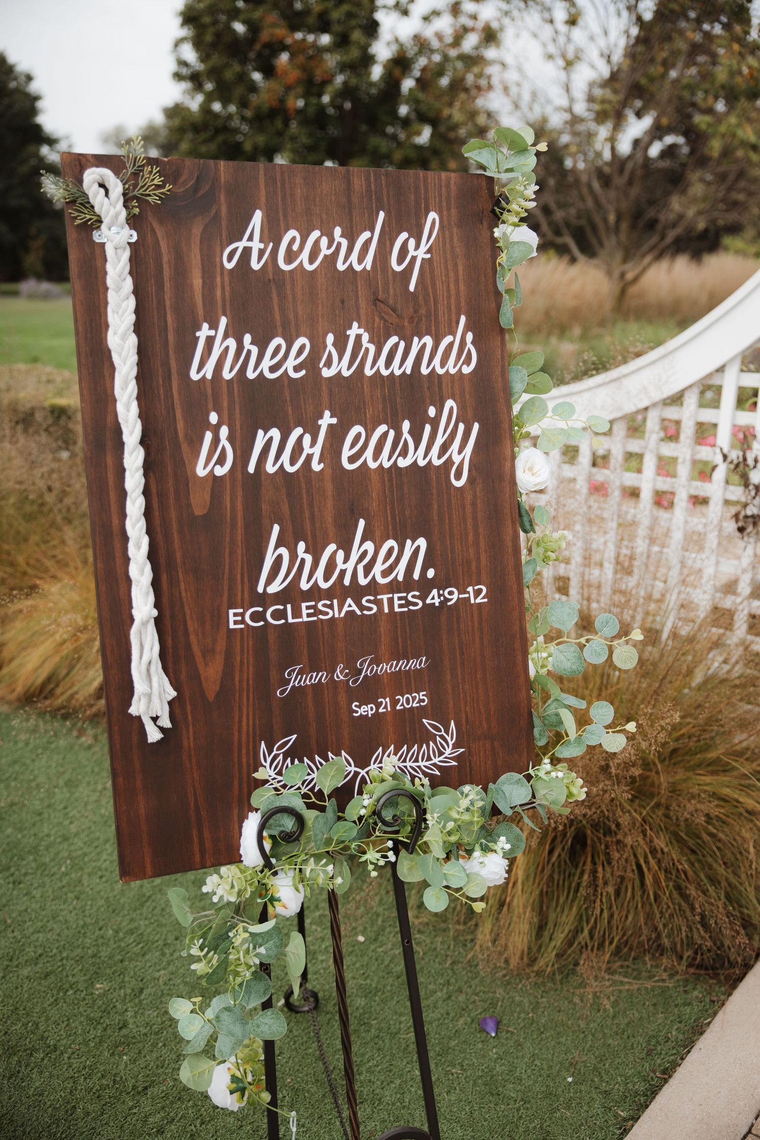 Wooden wedding sign with Ecclesiastes 4:9-12 cord of three strands quote decorated with eucalyptus.