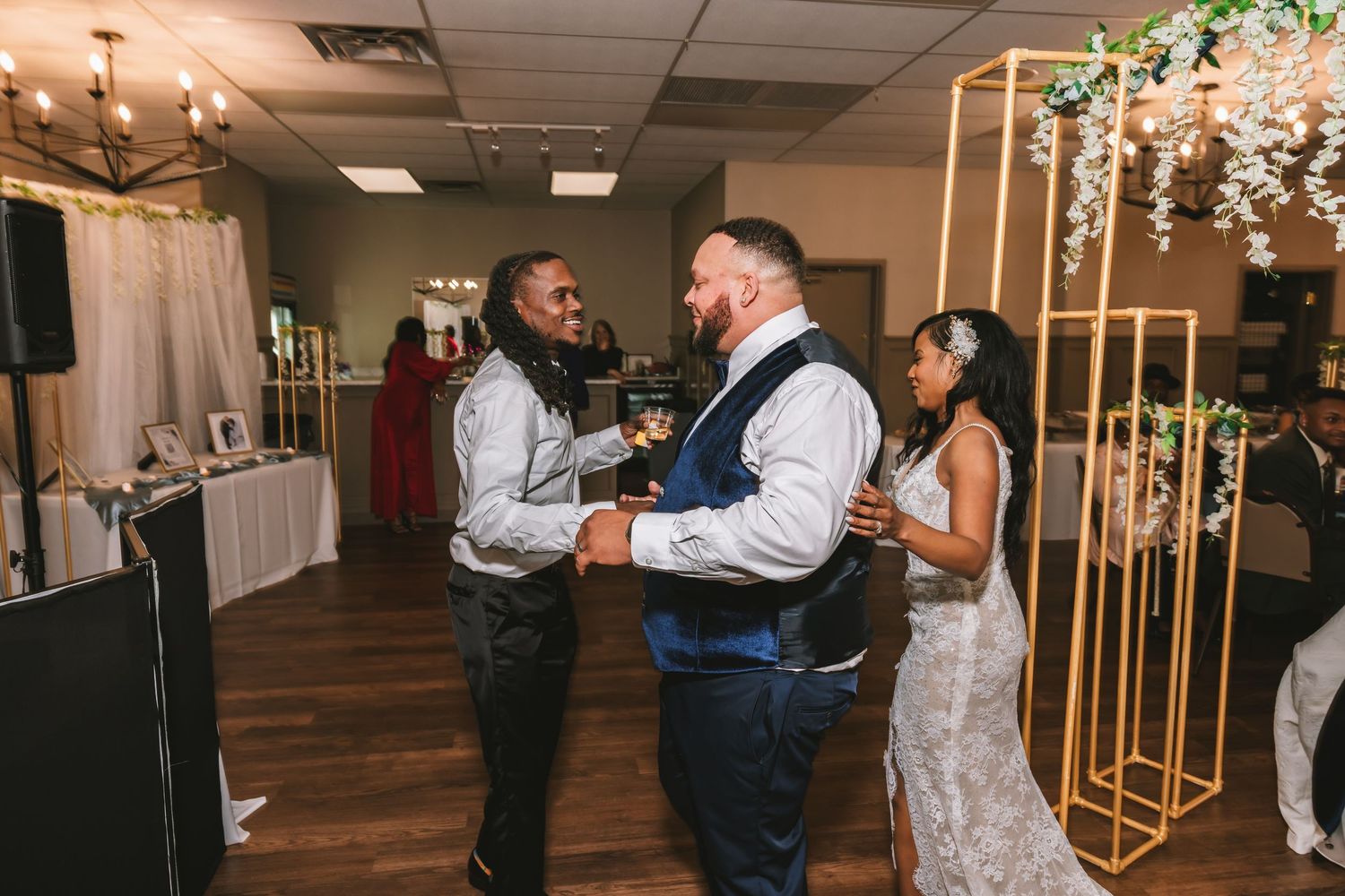 Guests dancing and celebrating with the bride at a wedding reception.