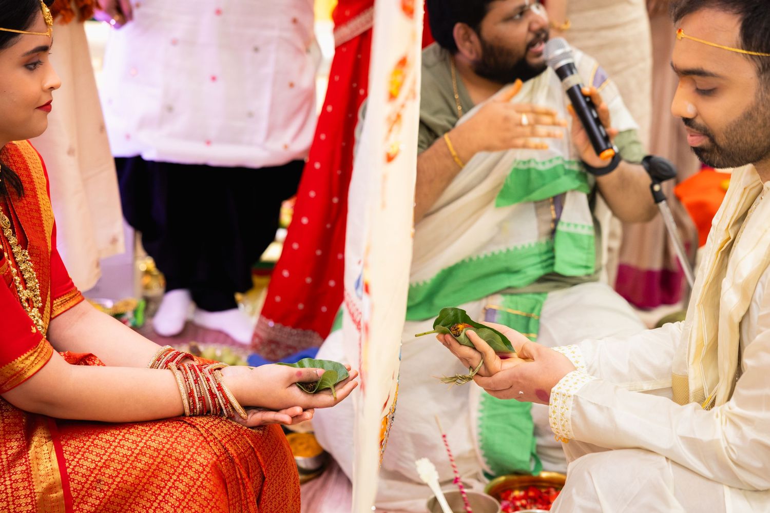 Indian wedding ceremony ritual with bride and groom exchanging offerings during traditional Hindu marriage.