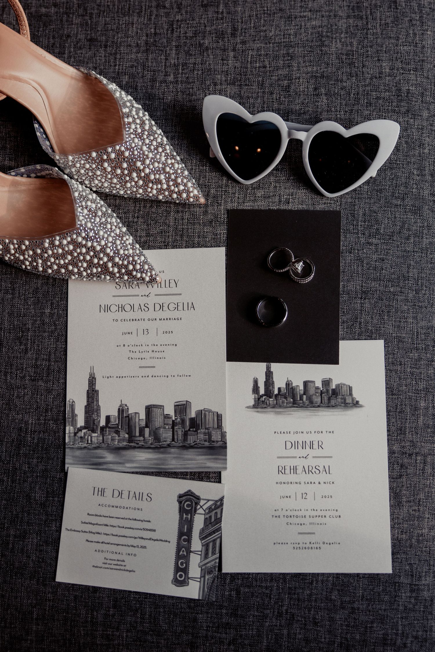 Black and white Chicago wedding invitation suite with heart sunglasses, rings, and pearl heels.