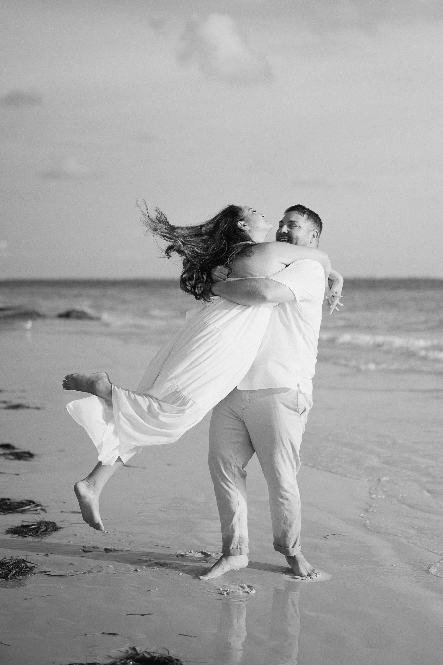 A romantic sequence of black and white photos shows a couple dancing and embracing on a beach at sunset.