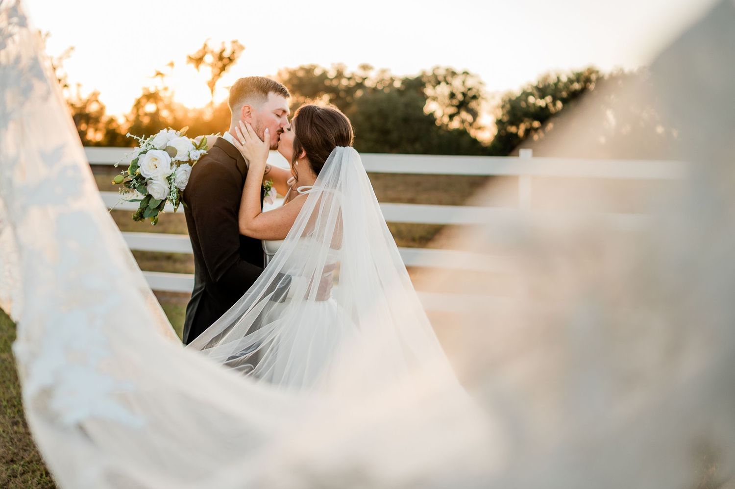 A bride in a flowing white wedding gown twirls gracefully during golden hour, creating a dreamy ethereal effect.