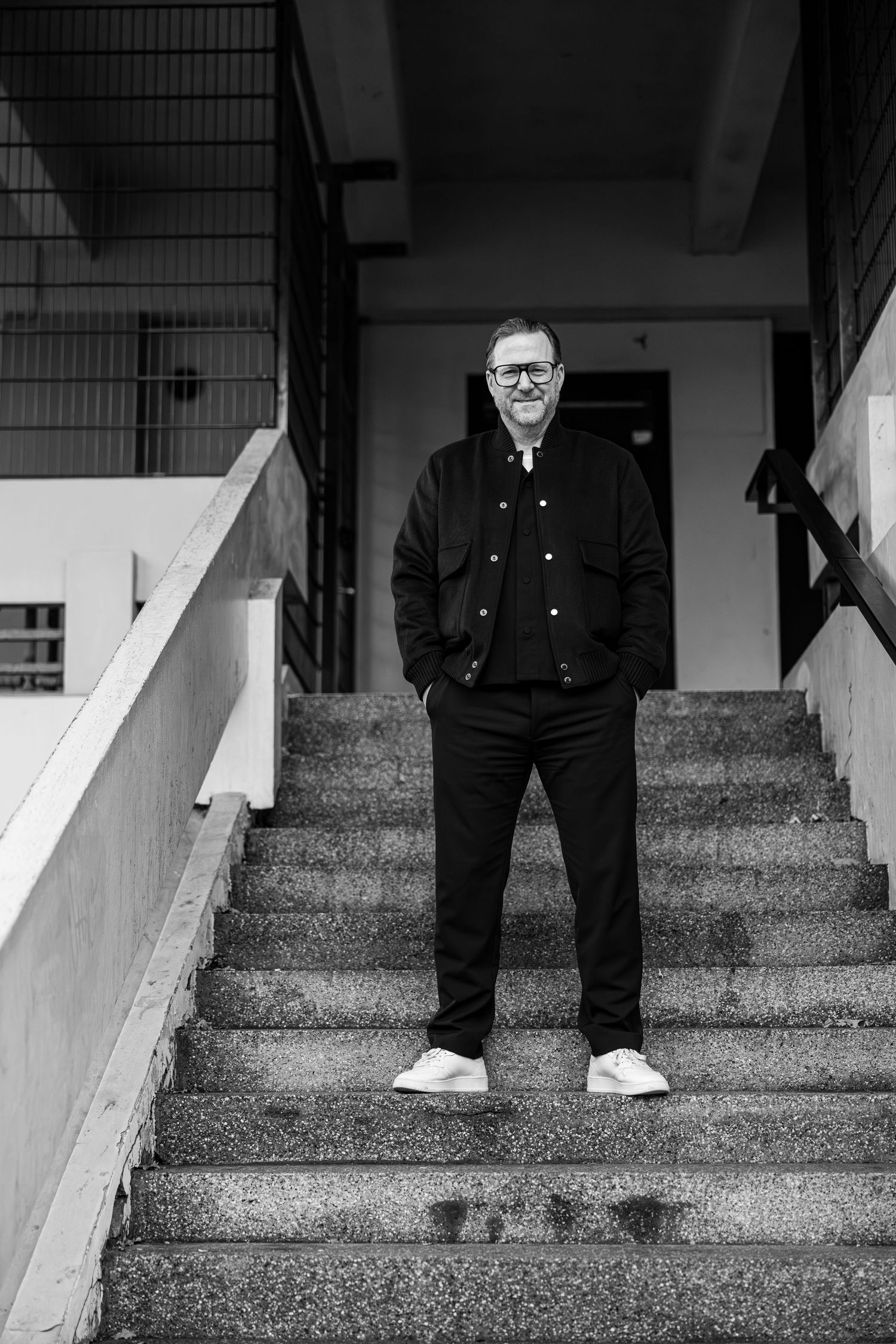 A black and white photo sequence shows someone in dark clothing walking down concrete steps.