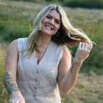 Outdoor portrait session in a natural field setting during golden hour.