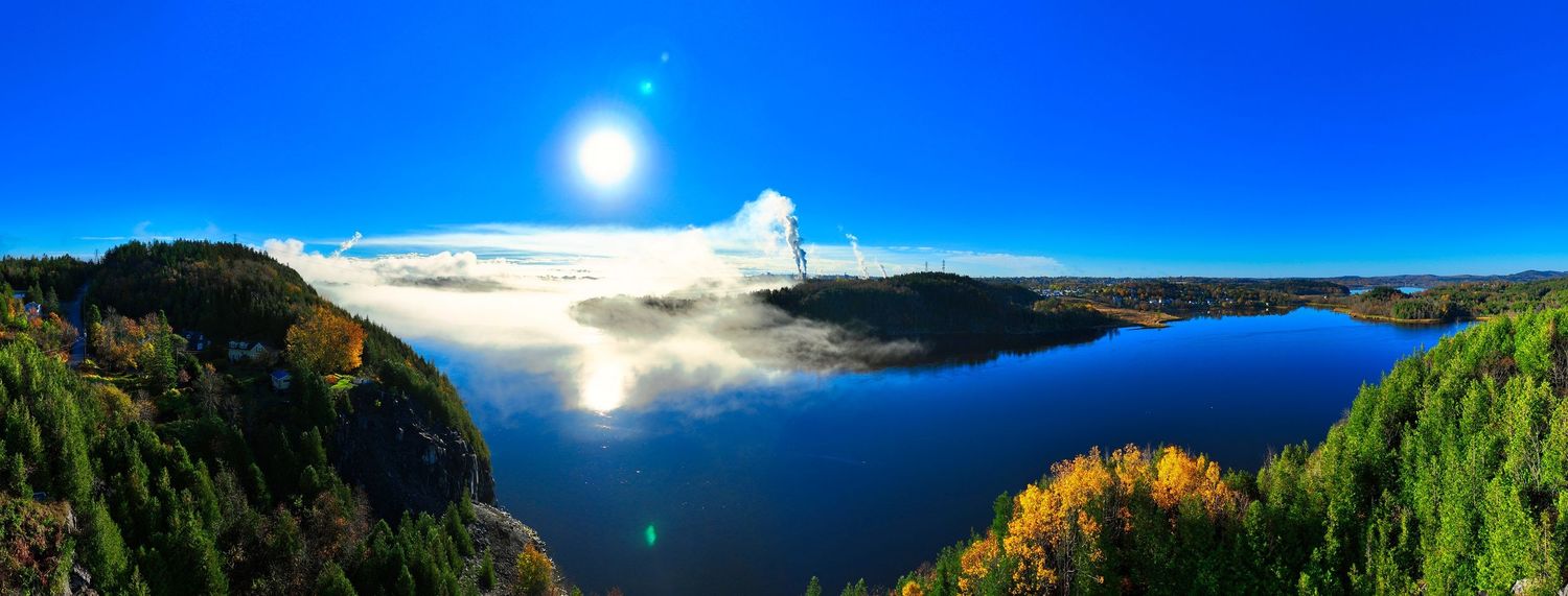 Bright blue sky panorama with sunburst and hilly landscape views, near Saint John River.