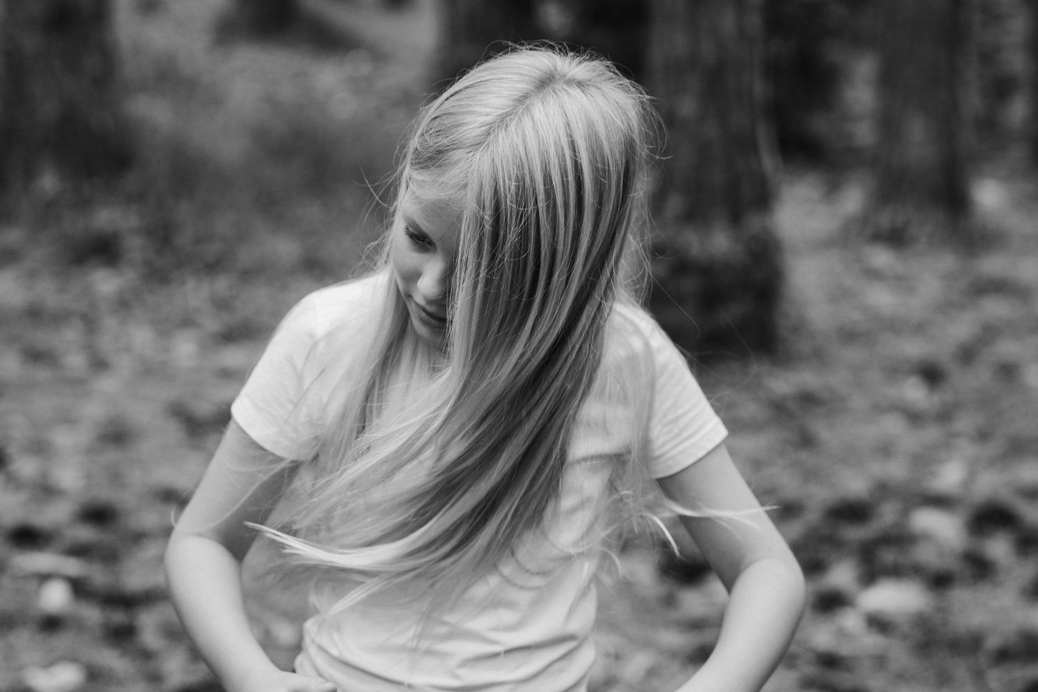Black and white portrait showing candid expressions in a wooded setting.Pizzey park family photos. Gold Coast