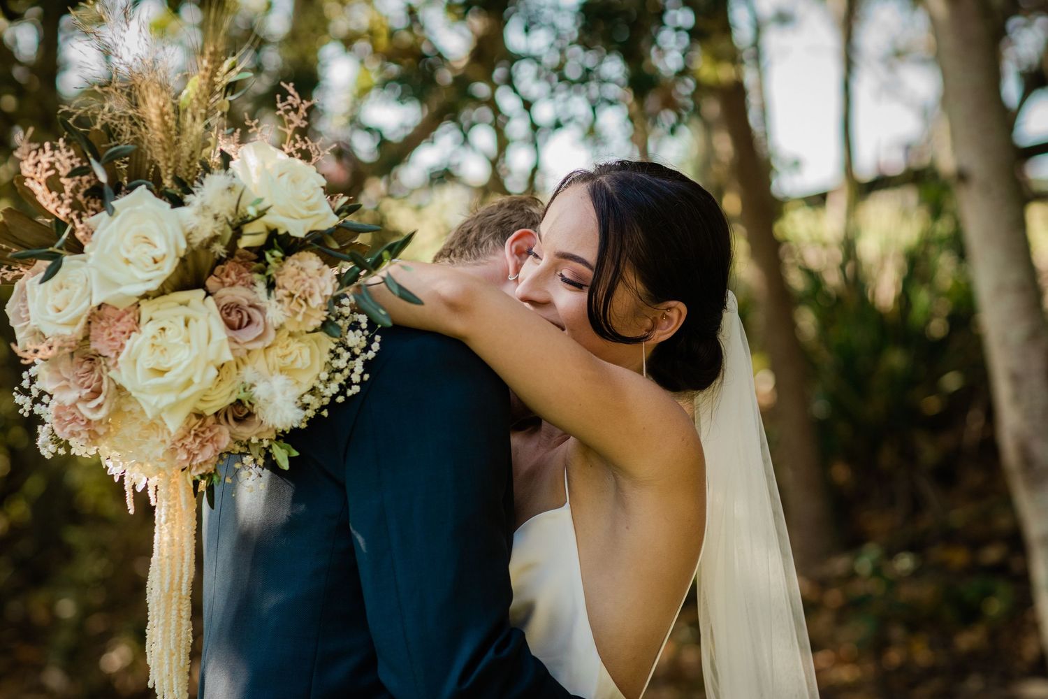 Golden hour wedding portraits with natural sunlight filtering through trees.