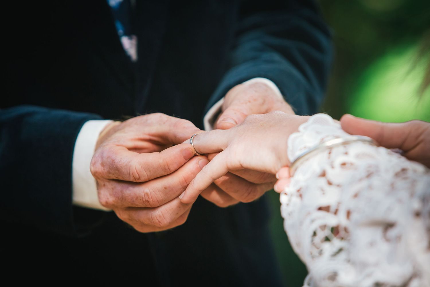 Close-up shots of hands exchanging rings during wedding ceremony.DIY wedding Gold Coast elopement photographer Gold Coast