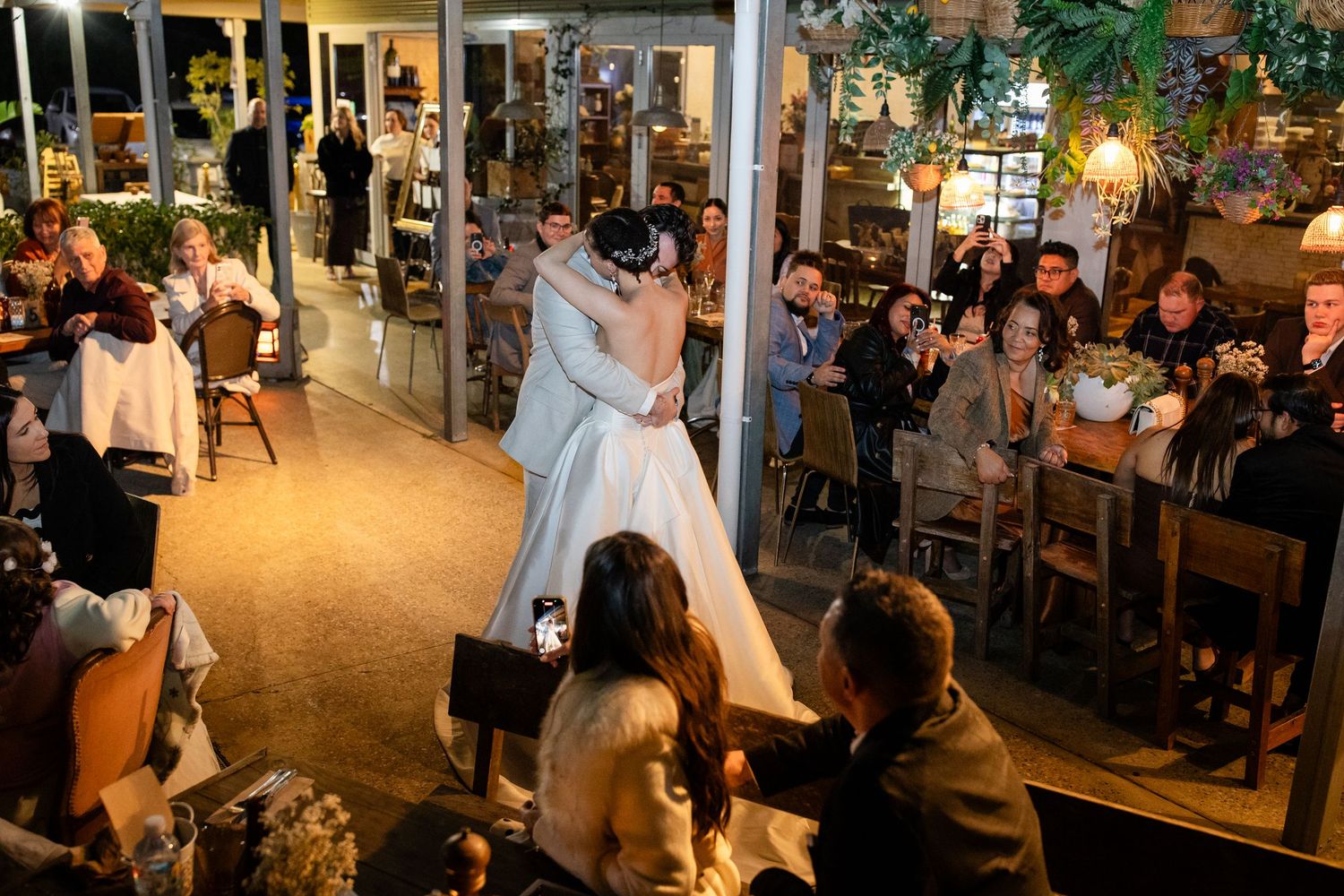 Large wedding reception venue with guests dancing and celebrating under string lights.Currumbin Valley wedding photography Gold Coast
