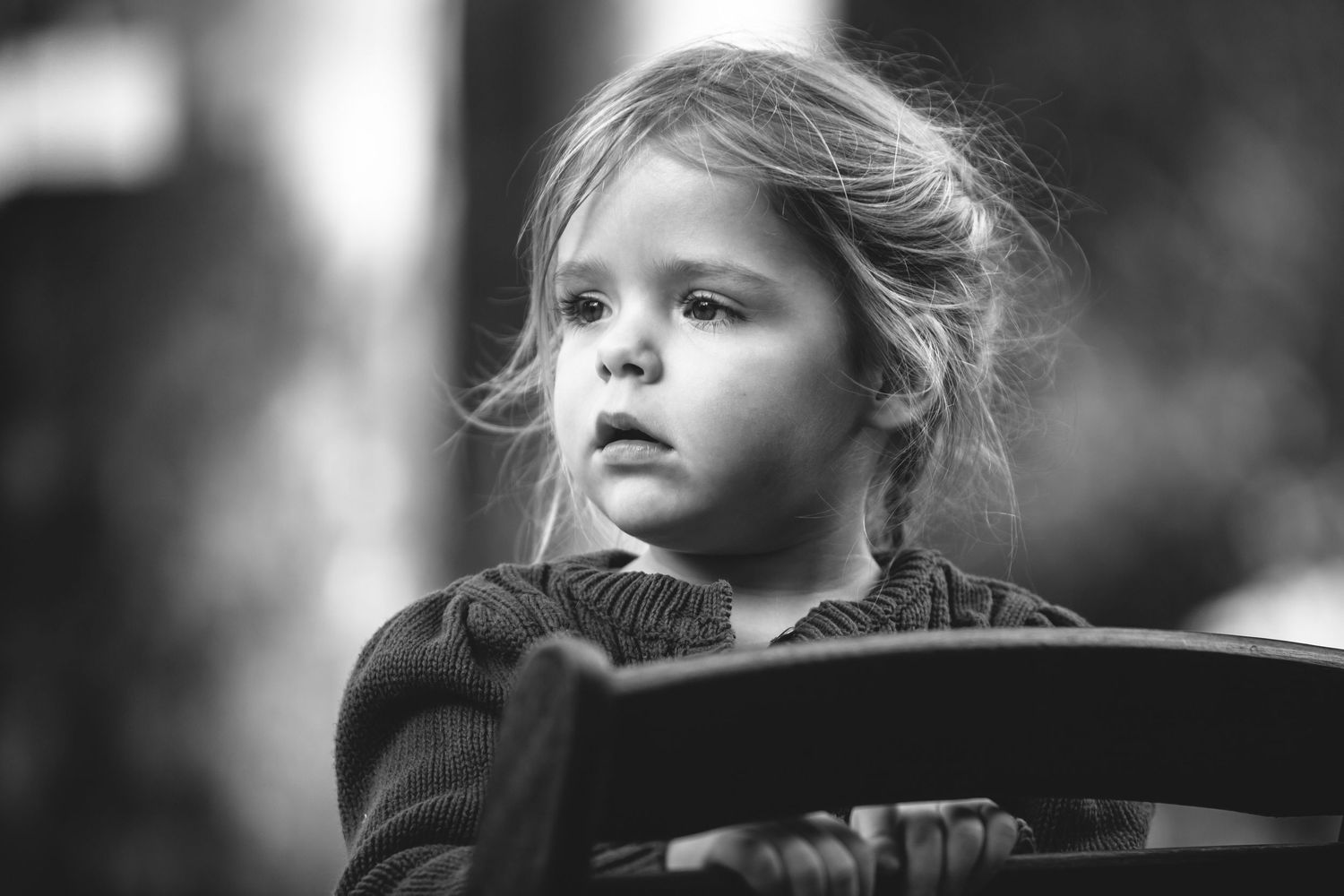 Black and white artistic portrait with dramatic lighting and shadows.