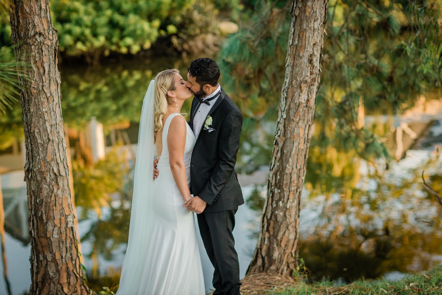 Newlyweds share intimate moment during sunset photoshoot in forest setting.v Surfers Paradise Golf Club wedding.