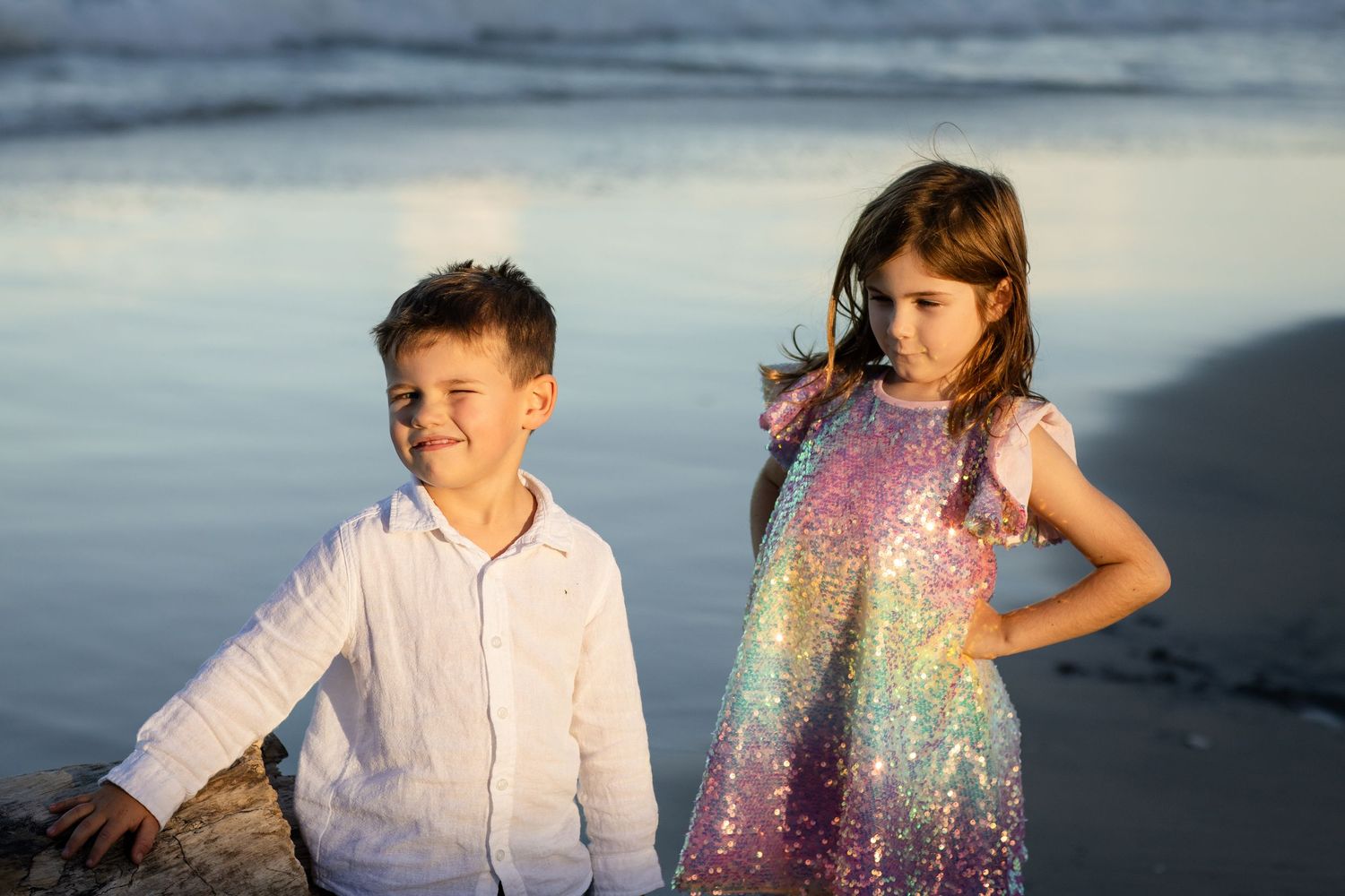 Sunset beach portrait session featuring sparkly dress and casual white clothing.Family photography cabarita New South Wales