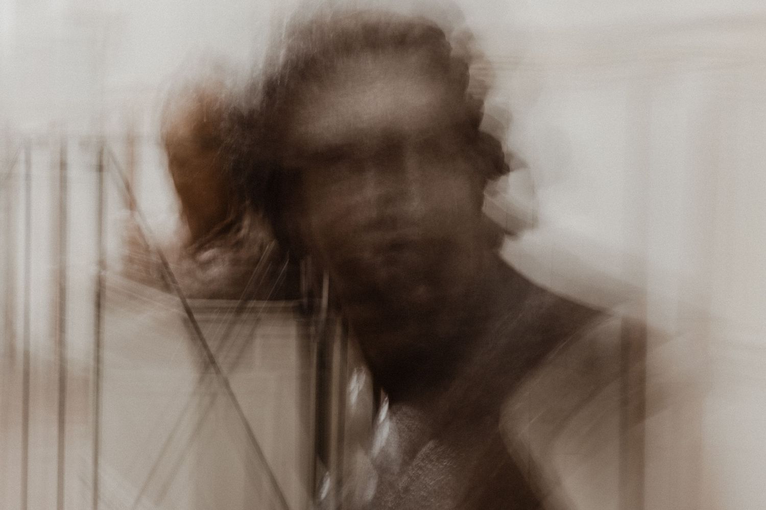 Sepia toned abstract portrait series with motion blur creating ethereal effect.