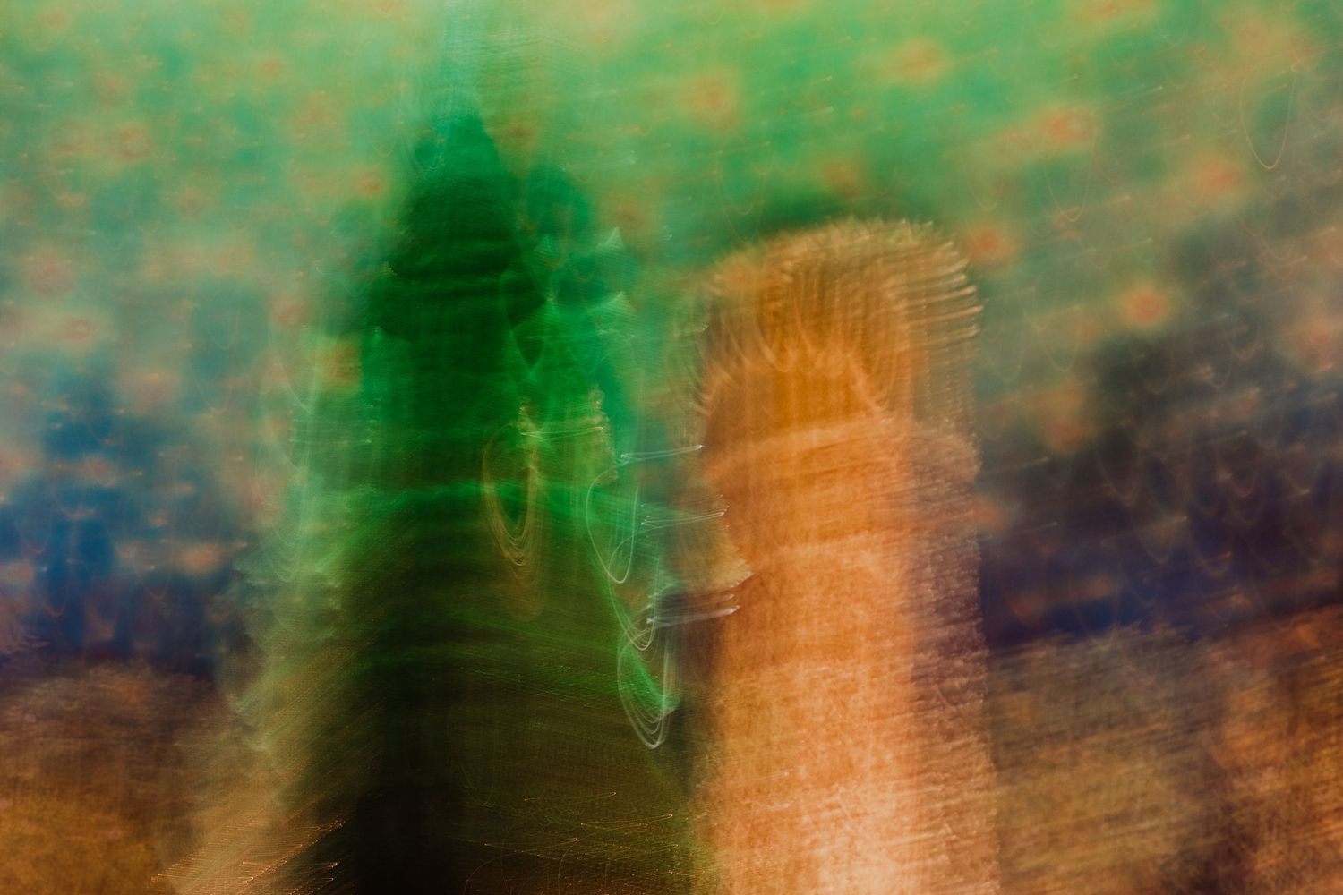 Vibrant abstract art with green and orange colors blending in motion blur effect.
