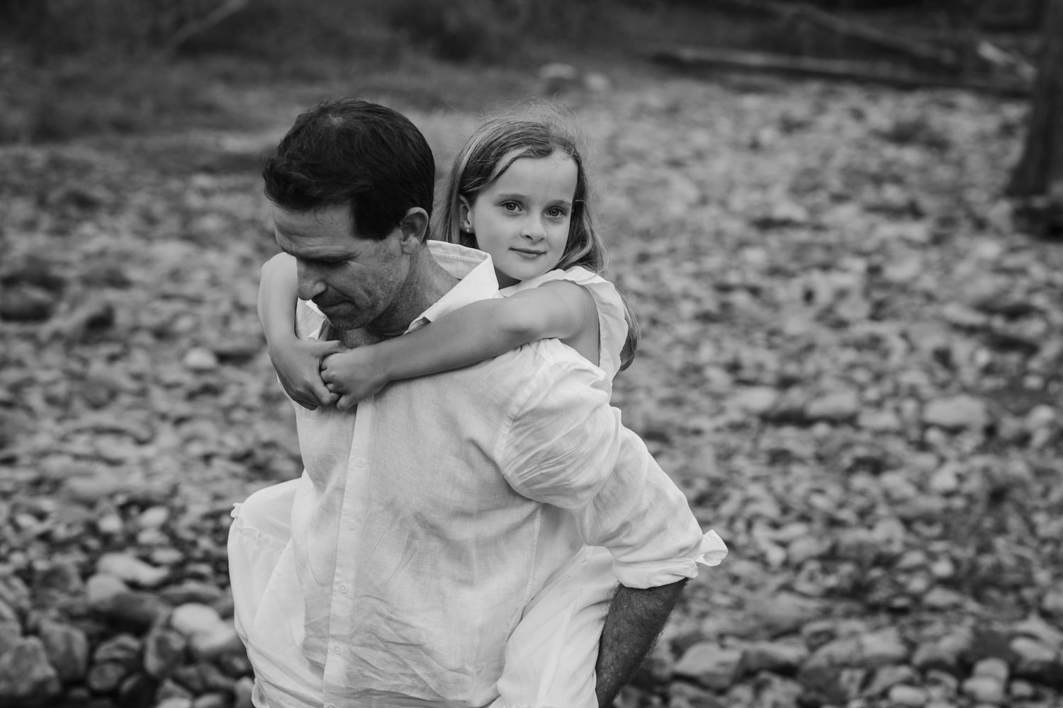 Sweet candid moments captured in black and white of embracing subjects in a forest setting.Tallebudgera family photography. Gold Coast famil